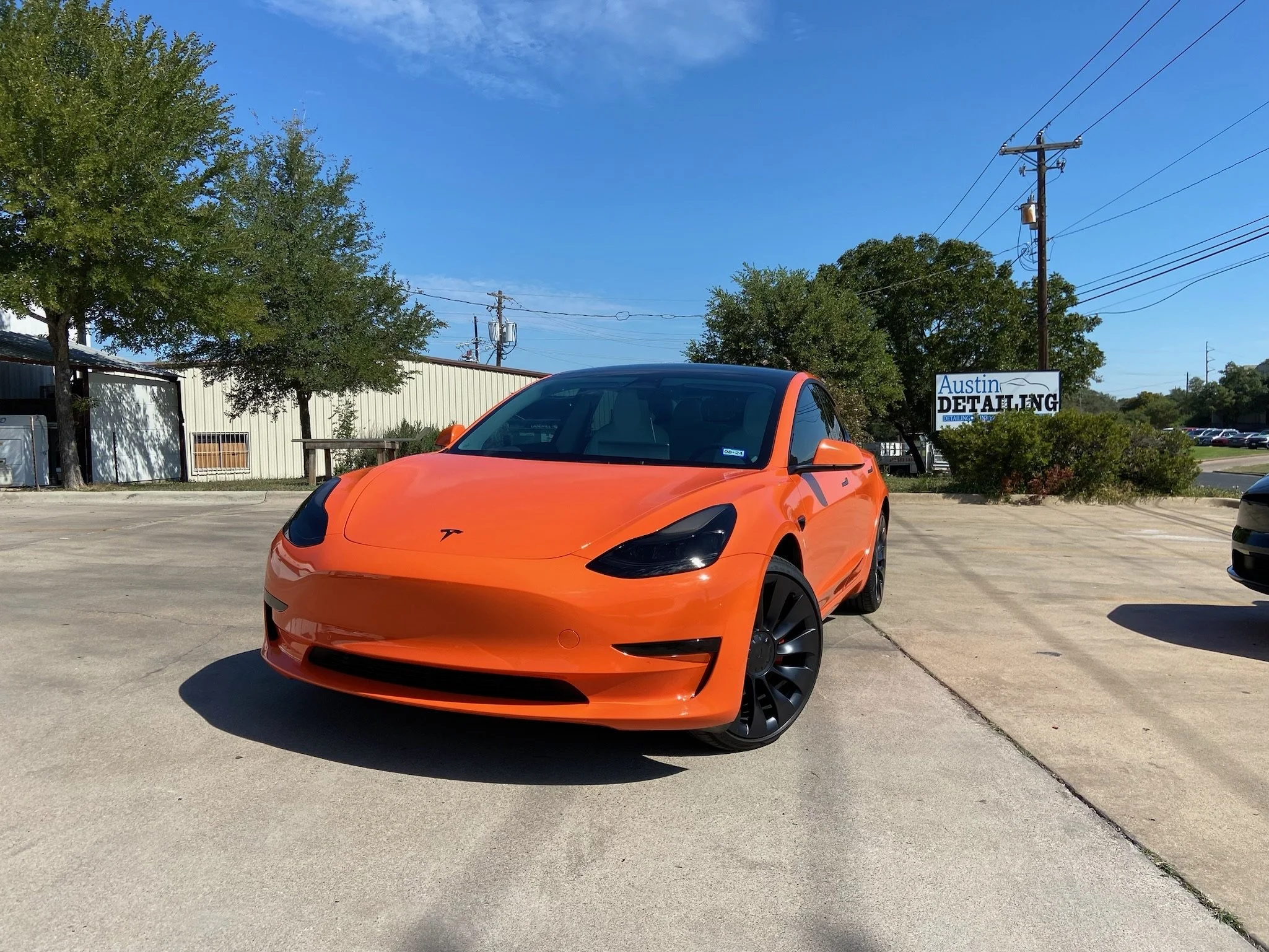 orange Tesla Model 3 with wrap