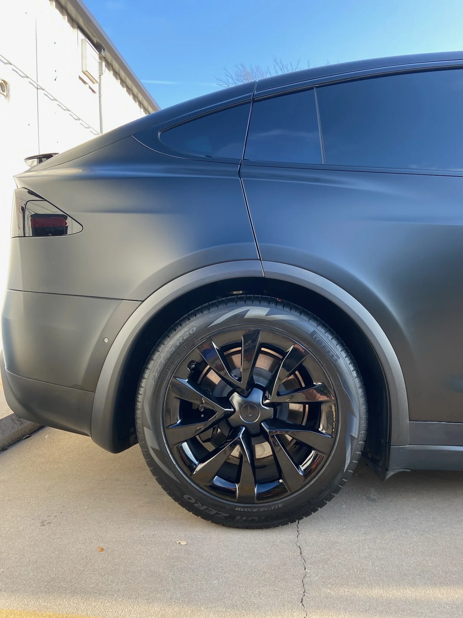 gray wrapped Tesla Model Y with powder coated wheels