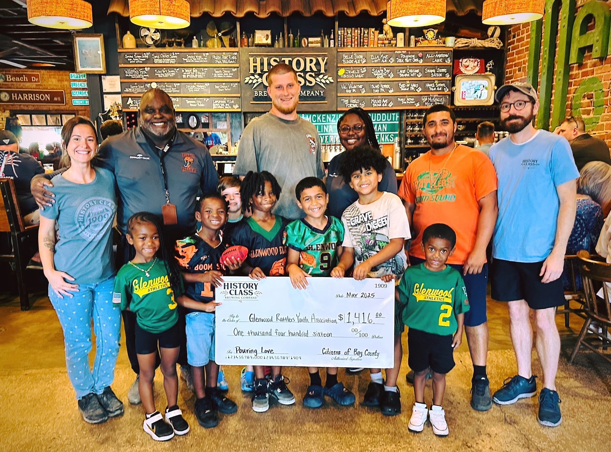 staff presenting check to charity