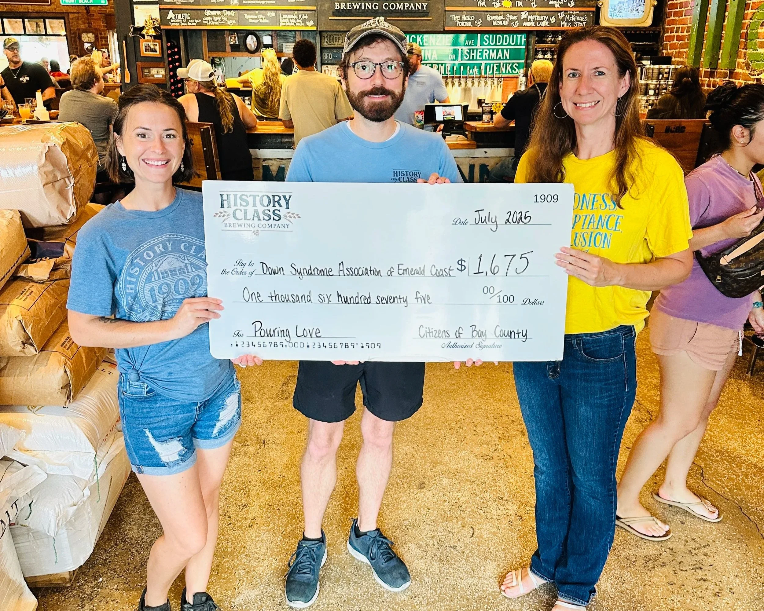 staff presenting check to charity