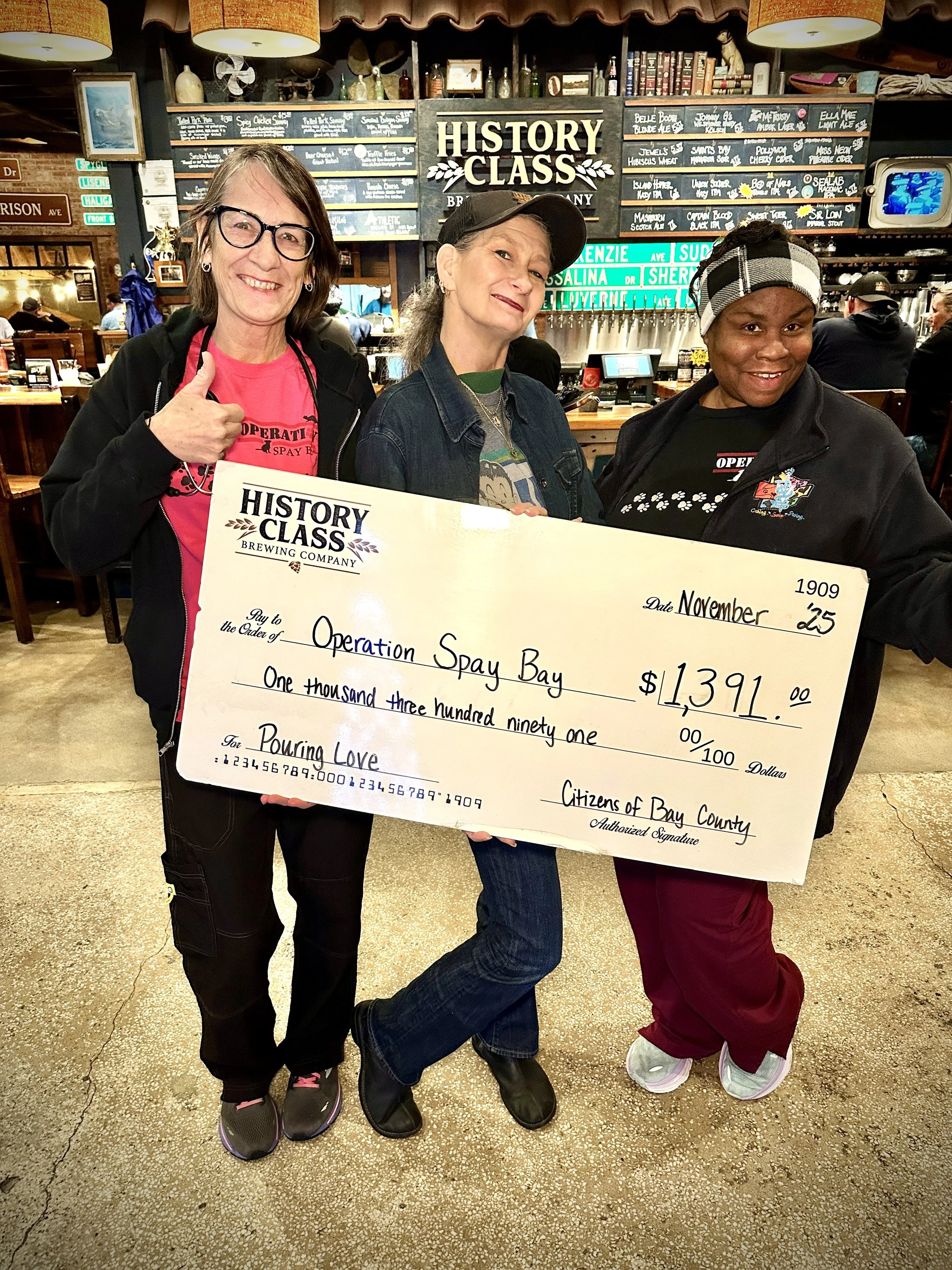 staff presenting check to charity