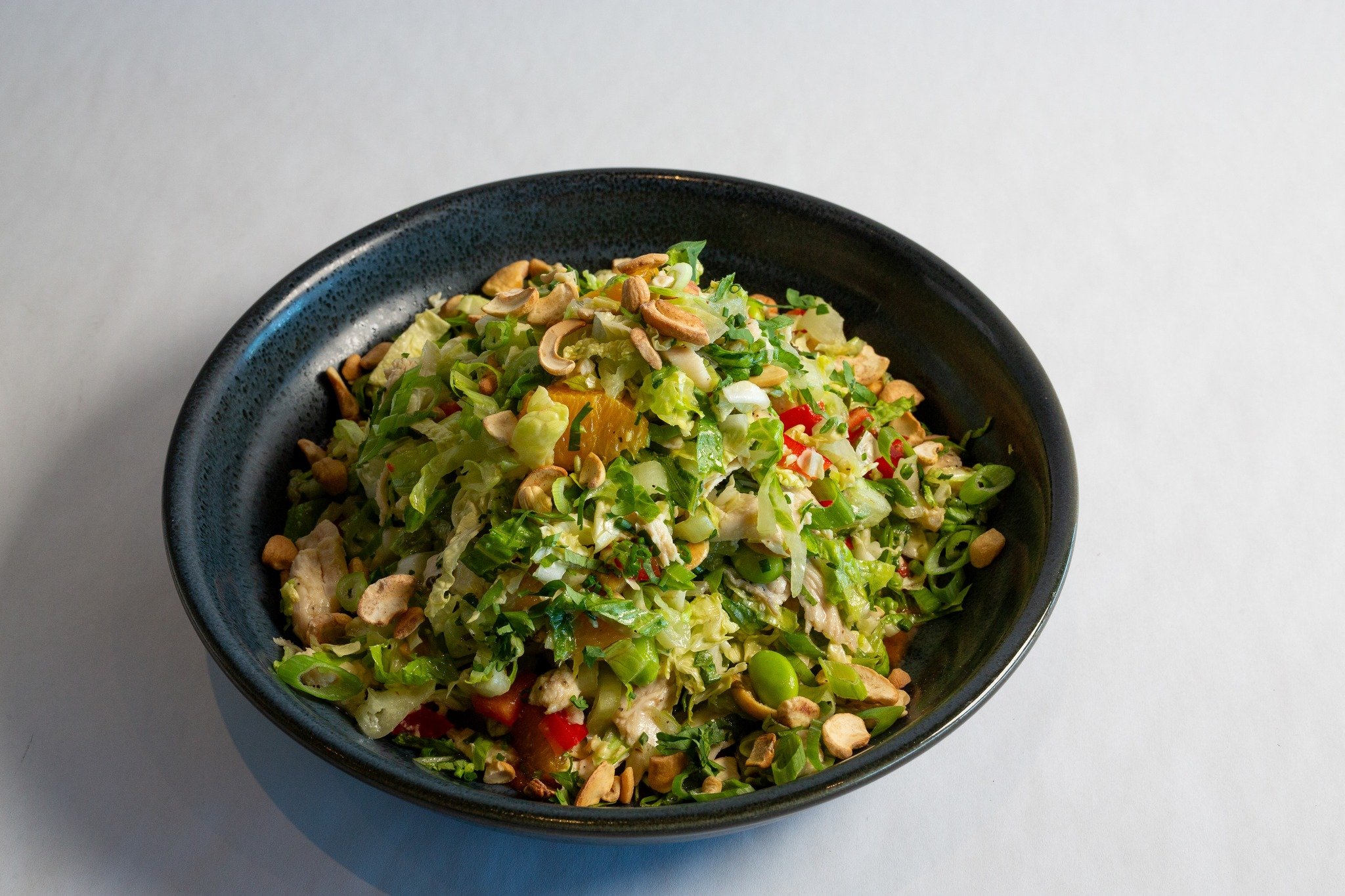 Crunchy, colorful, and full of flavor! 🥗 Our Asian Chicken Salad has everything&mdash;crisp romaine, napa cabbage, edamame, red bell pepper, orange, and cashews tossed in a peanut sauce + honey-lime vinaigrette. Sweet, savory, and straight-up delici