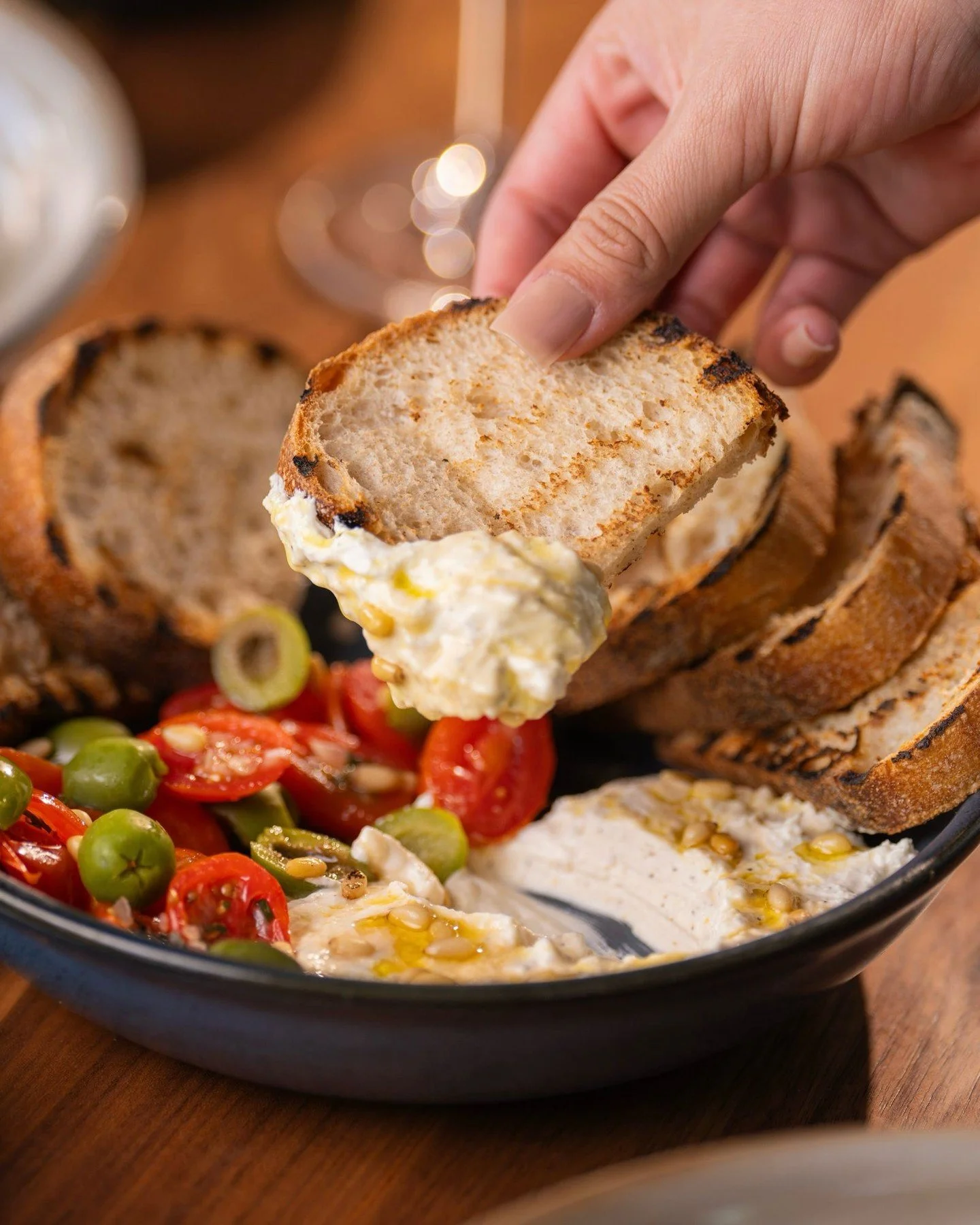 A velvety bed of whipped feta topped with tomato, basil, Castelvetrano olives, pine nut, and a drizzle of hot honey &mdash; all served with warm Noble bread.

Simple ingredients. Elevated flavor. ✨

Oliver&rsquo;s Modern American 🥂

Sun - Thurs ➡️ 4