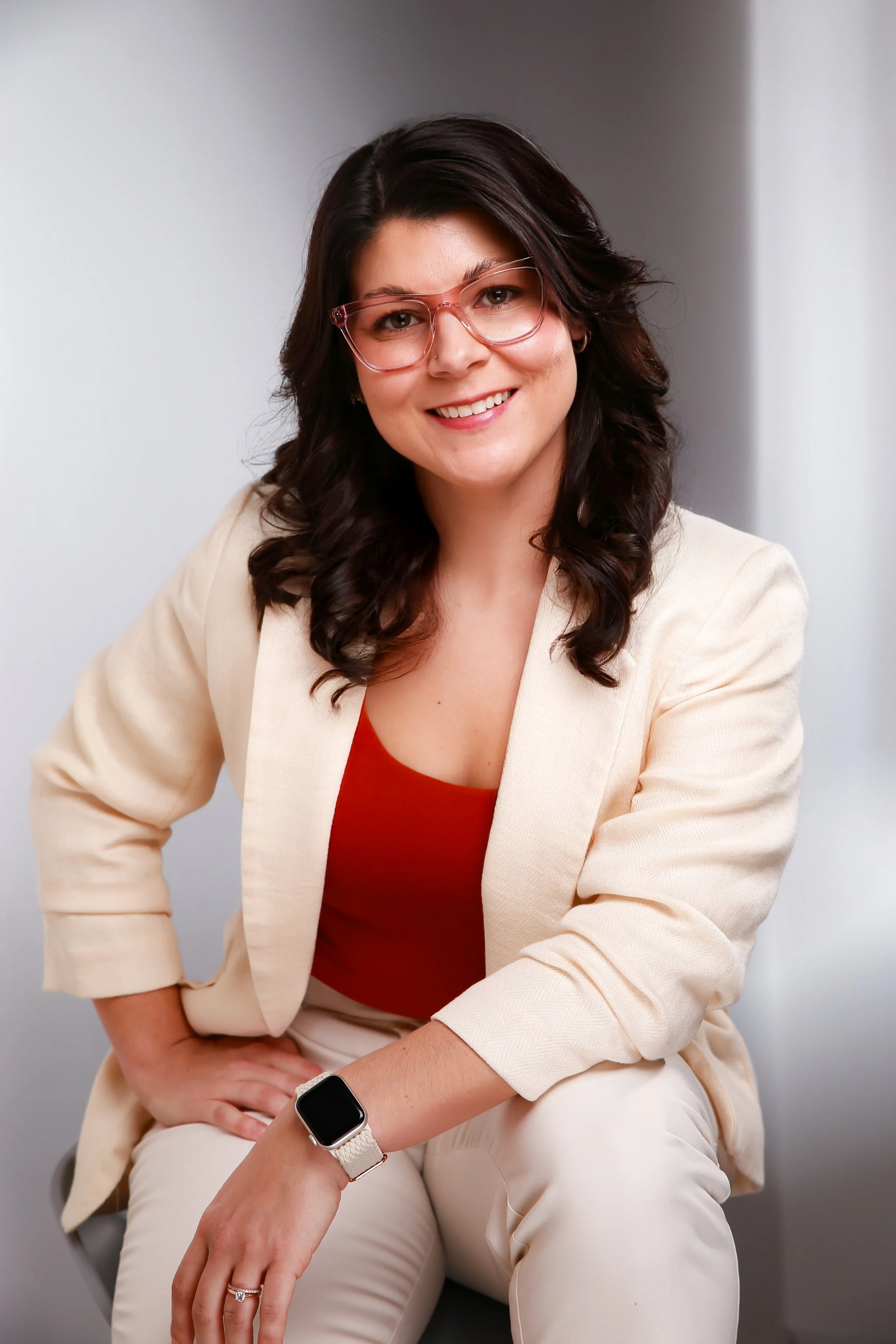 Therapist in McKinney, TX wearing glasses and smiling.