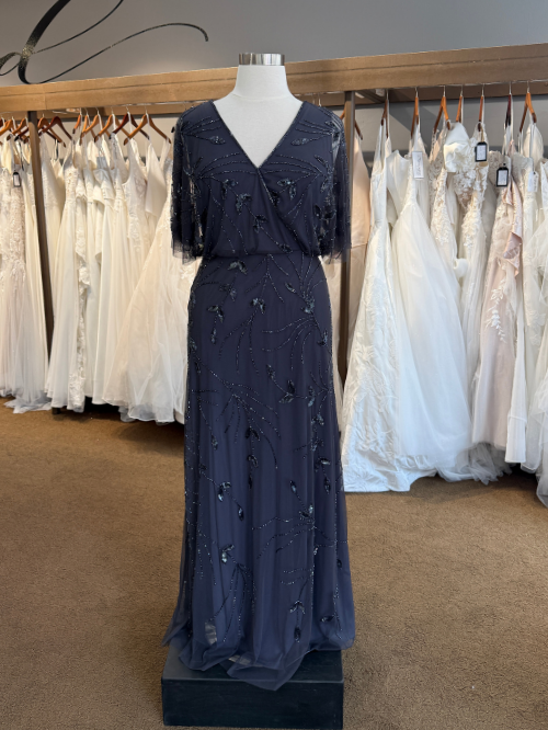 Dark Grey Beaded Mother's Dress on mannequin in front of wedding dresses