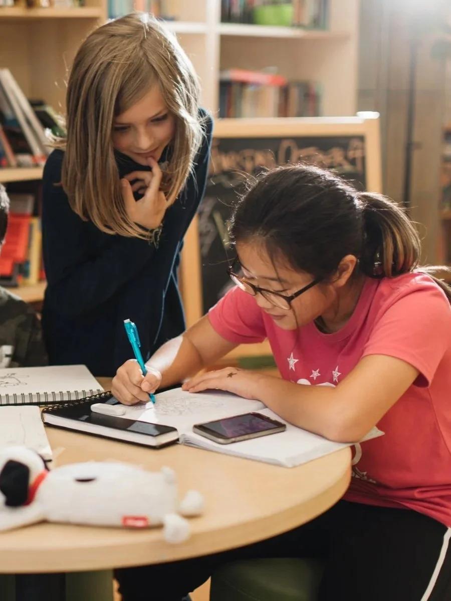 Students engaged in focused learning with individualized support in a small classroom environment