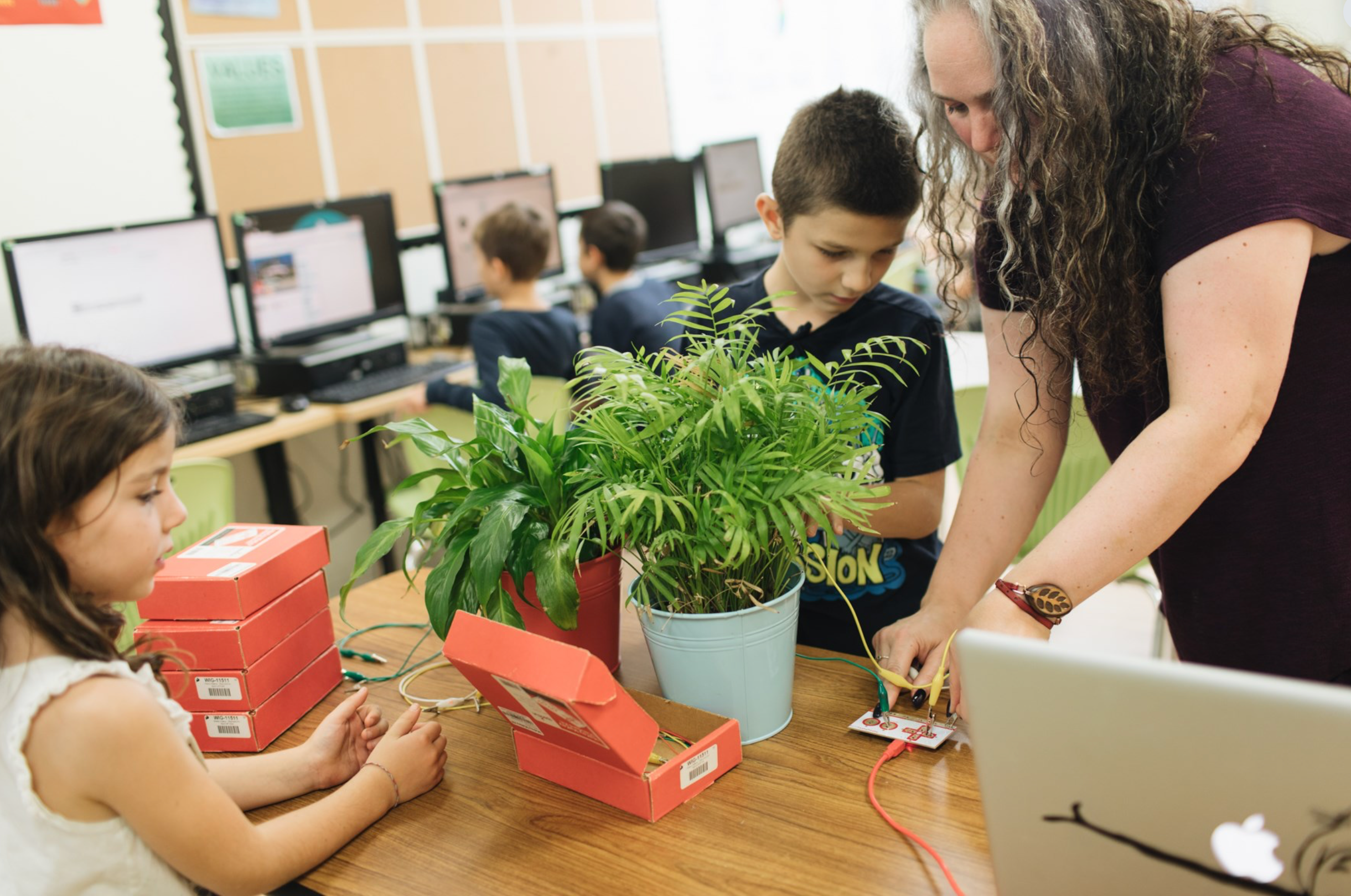 Student working with a teacher on a hands-on learning project that builds independence and problem-solving skills