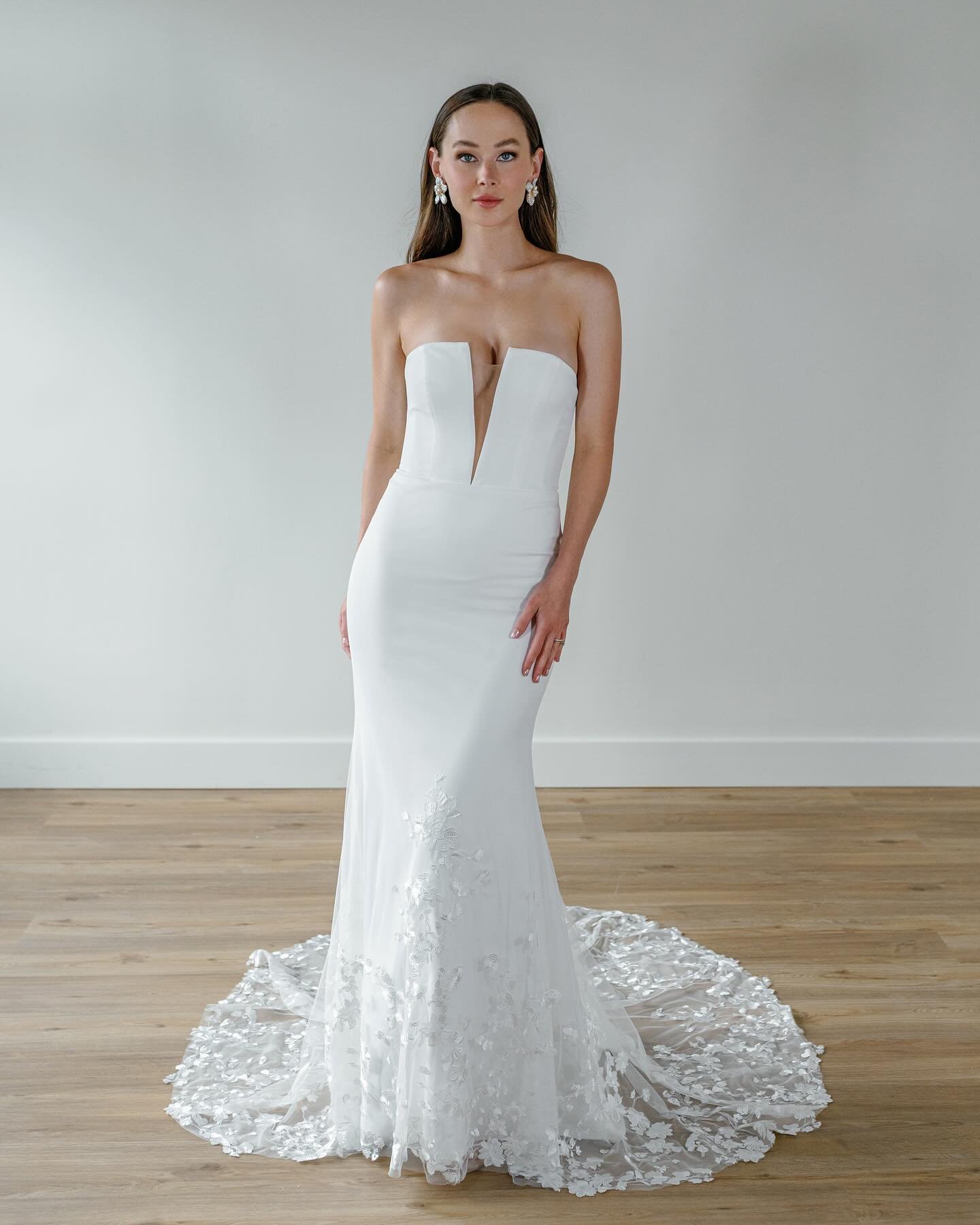 Another modern gown, Wellesley by @wtoowatters is a stunning fitted crepe dress that blooms at the bottom into gorgeous motifs. 

With a flattering fit and a plunging V-neck, you&rsquo;ll be turning heads all evening. 🤍✨ 

Schedule your appointment 