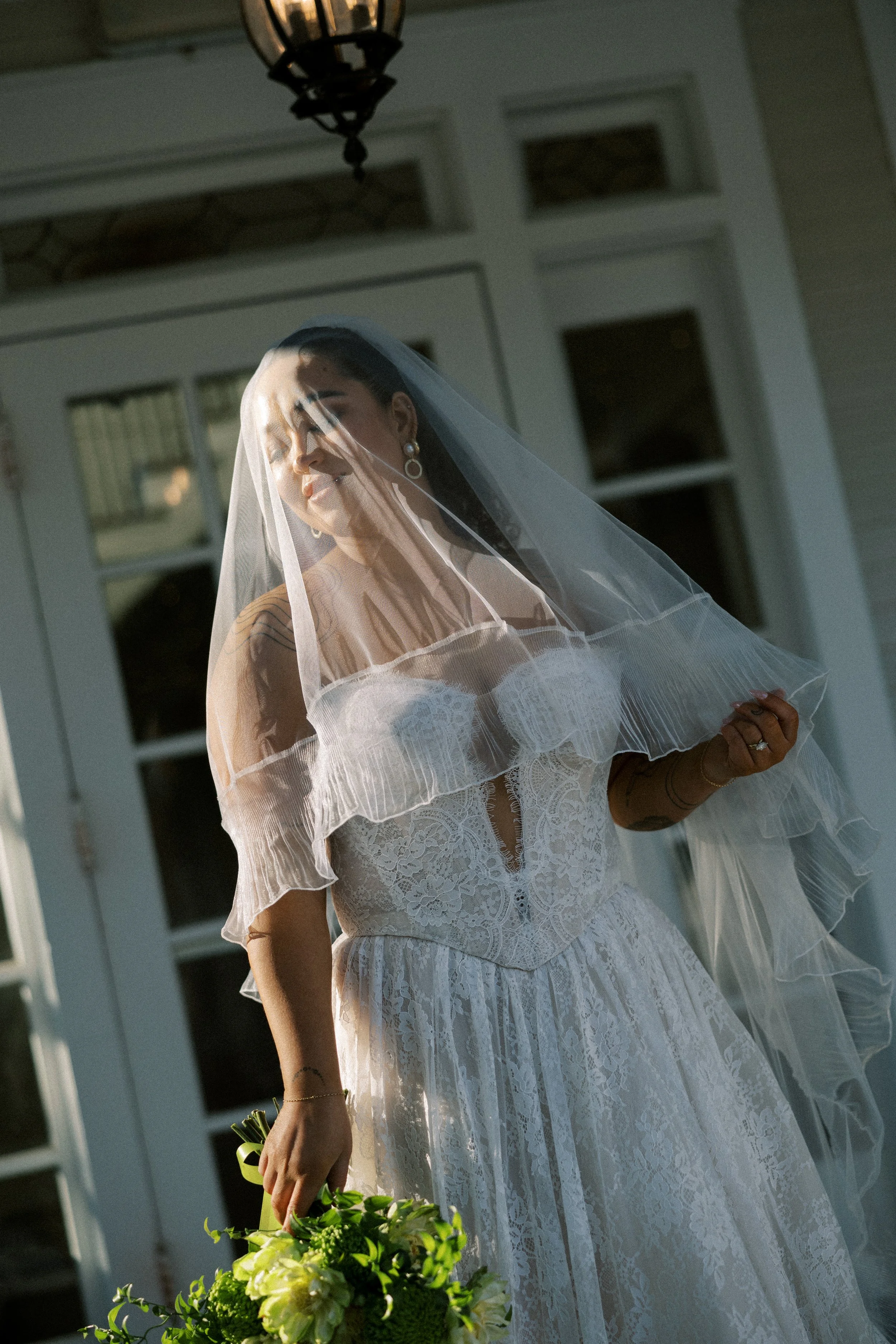 A girl wearing a lace wedding dress, Charlotte by Wtoo, from a Hickory, NC wedding dress shop