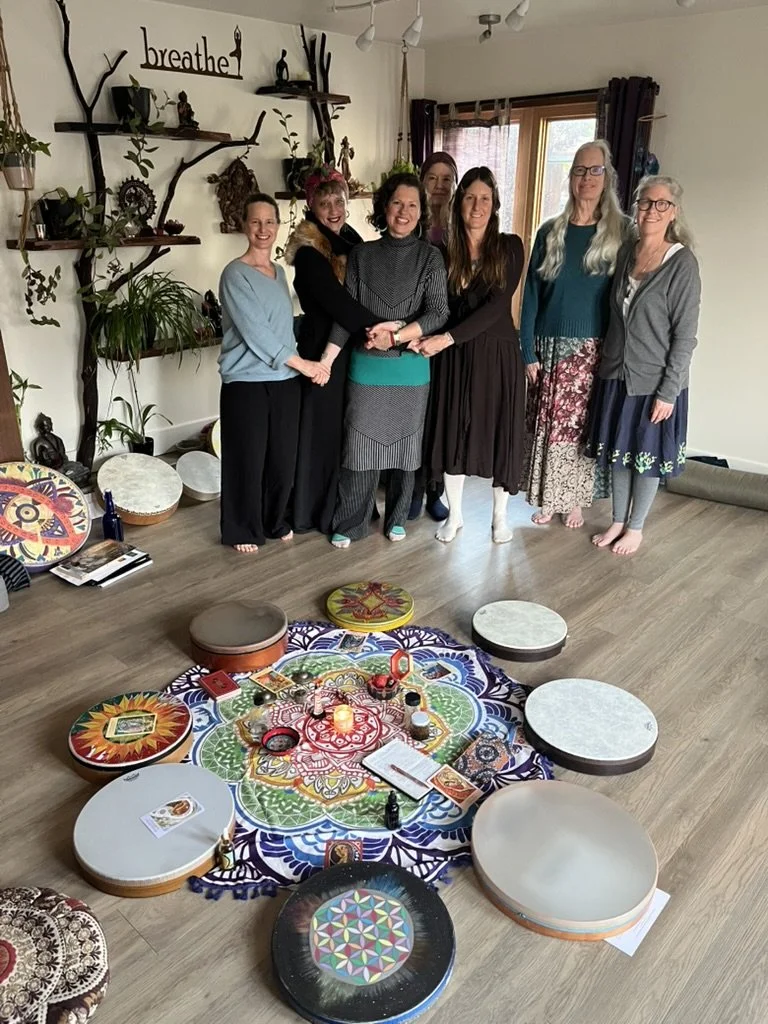 Intuitive Drum Song: an intimate group in Mendocino gathered beside a circle of decorated frame drums.