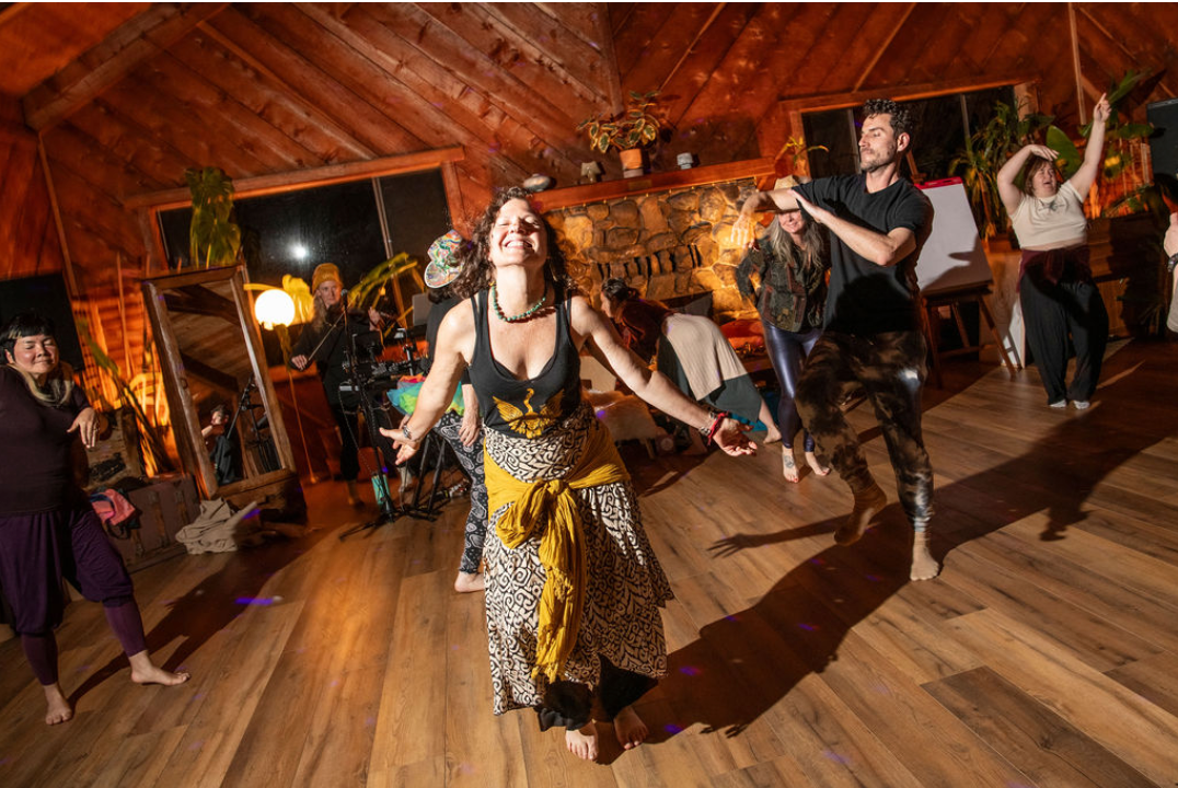 Honey Hive Ensemble moving and dancing together in a lively community performance.