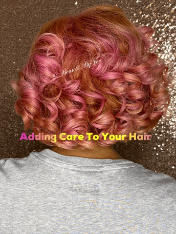 Back view of a person with pink curly hair against a glittery background, wearing a gray shirt, with text 'Adding Care To Your Hair' overlayed.