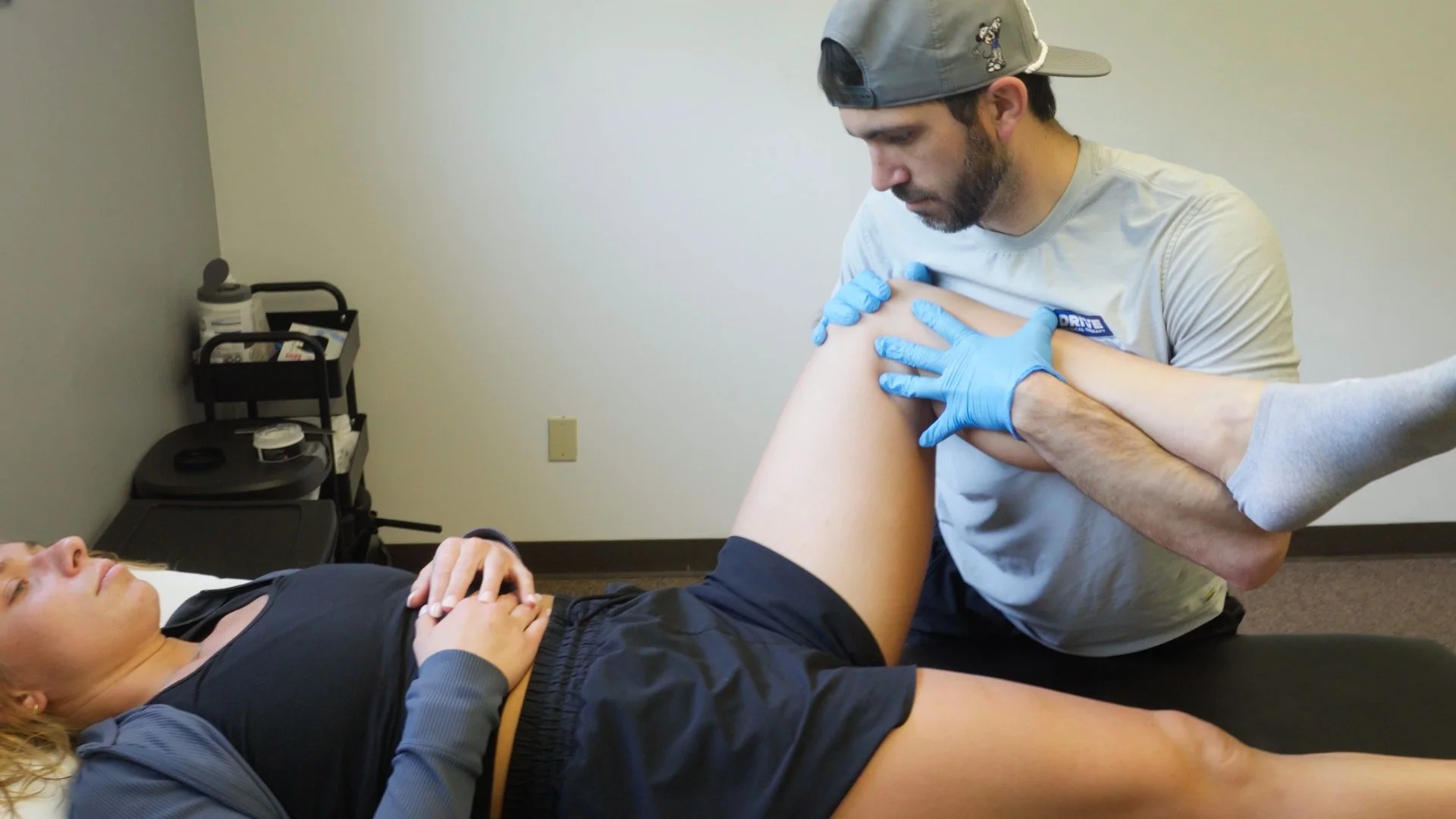 Doctor of Physical Therapy performing manual therapy and movement assessment at Drive PT Saratoga Spring