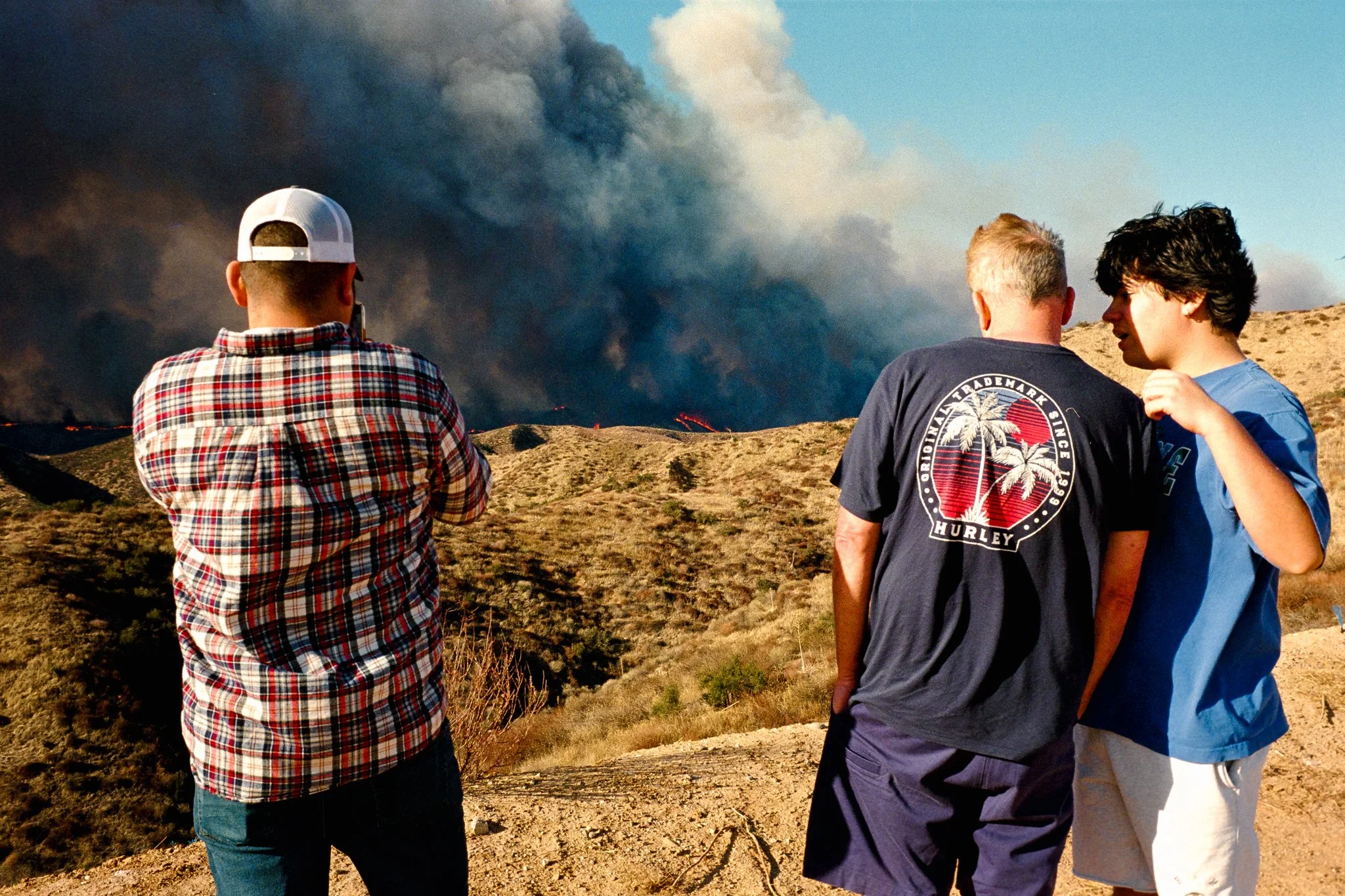 Local residents watch as the Hugh Fires get closer to the Tesoro Home Development in Valencia, California. January 22nd, 2025.