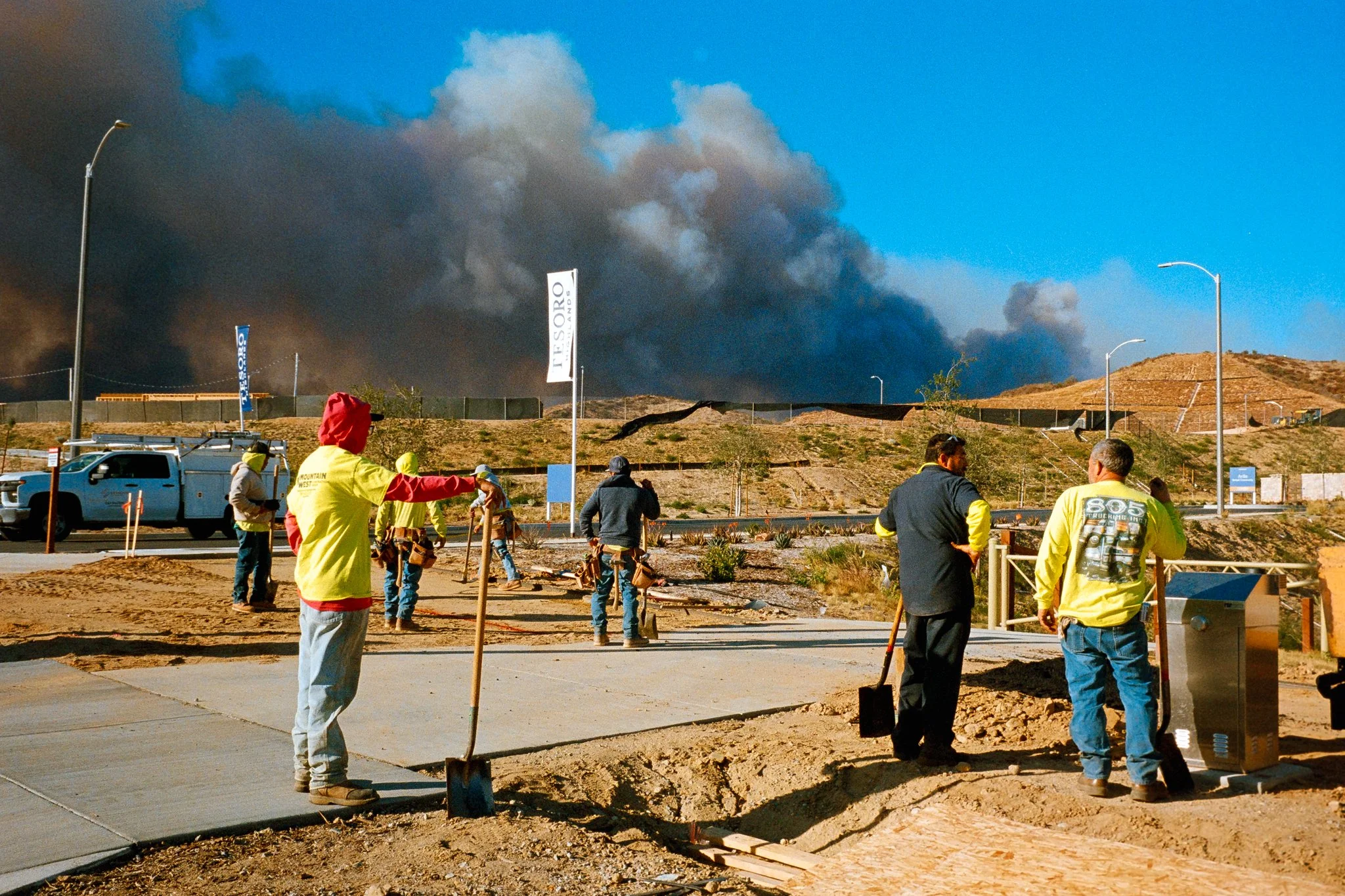 Construction workers take a break to watch incoming smoke from the Hughes Fire. January 22nd, 2025.