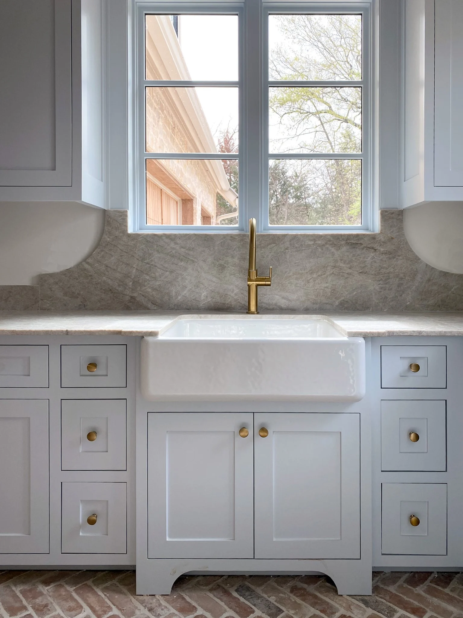 Farmhouse sink with blue cabinets and detailed backsplash_adjusted.jpg