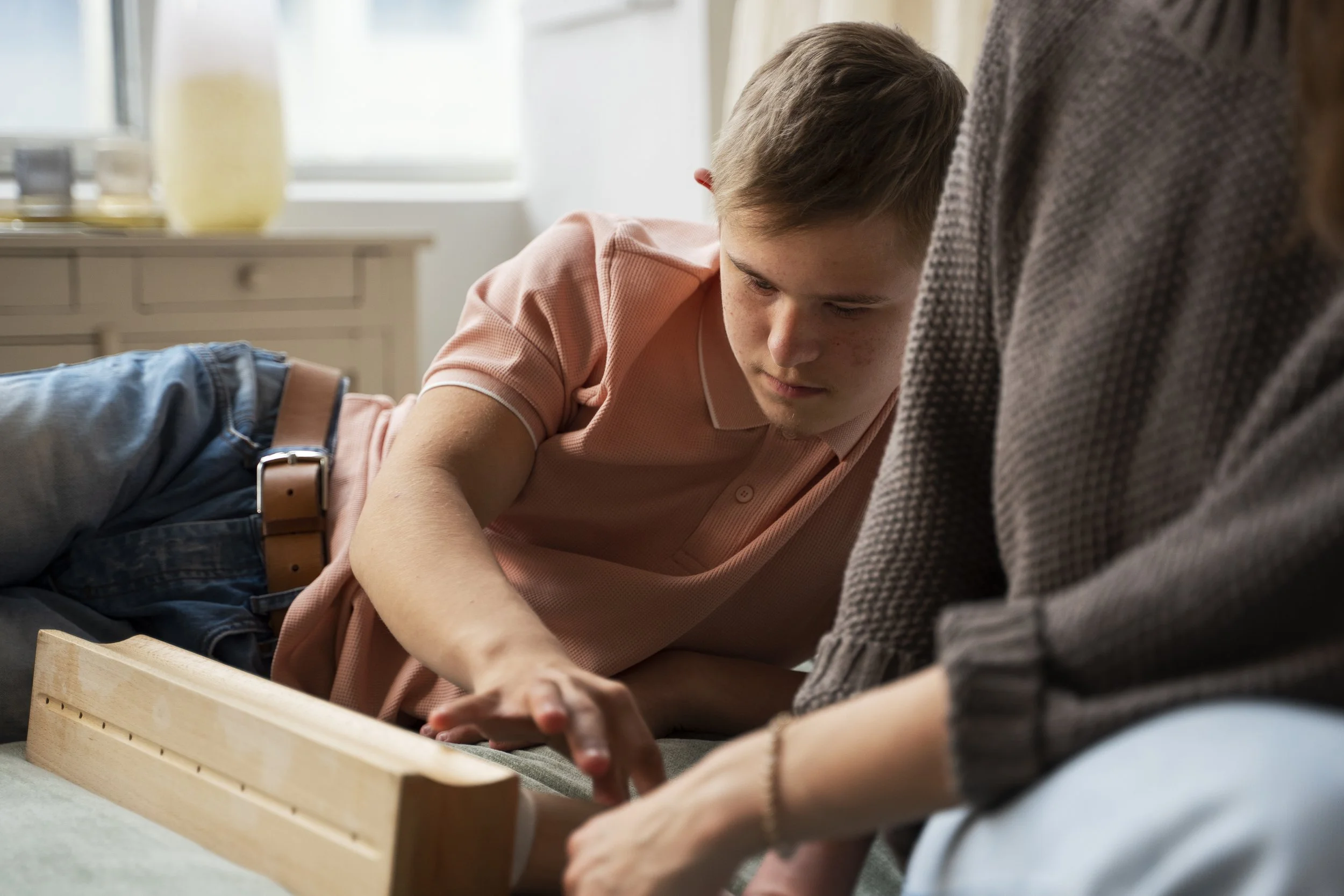 NDIS support worker assisting teenager at home Melbourne