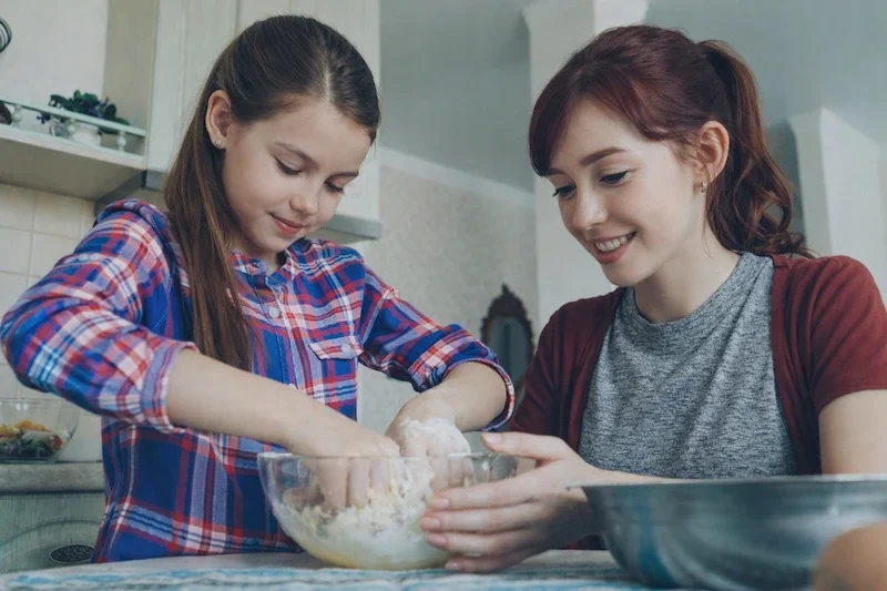 Support worker and teenager doing a practical life skills activity together