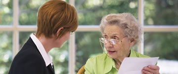 Funeral director with elderly client.