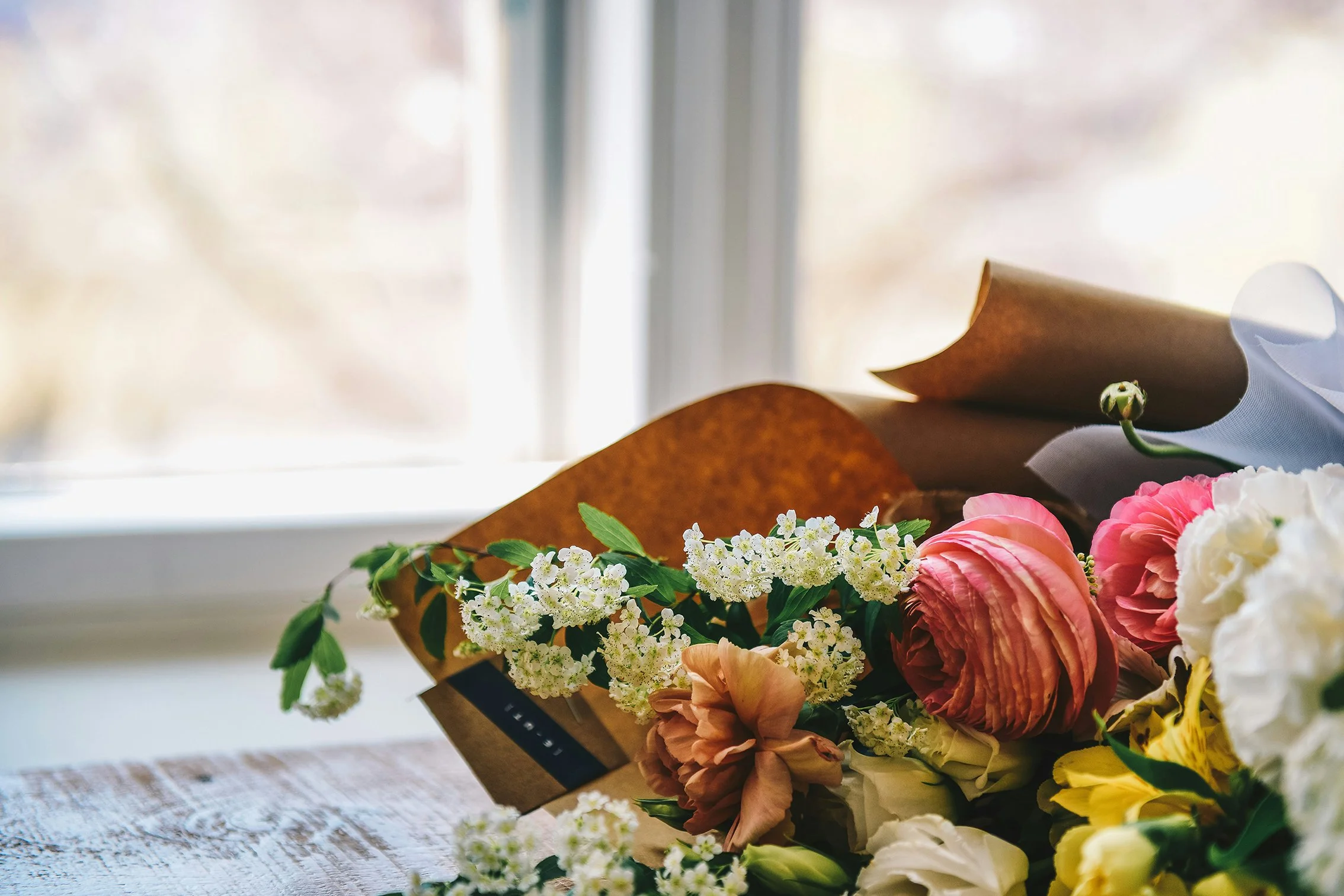 funeral flowers by window sill