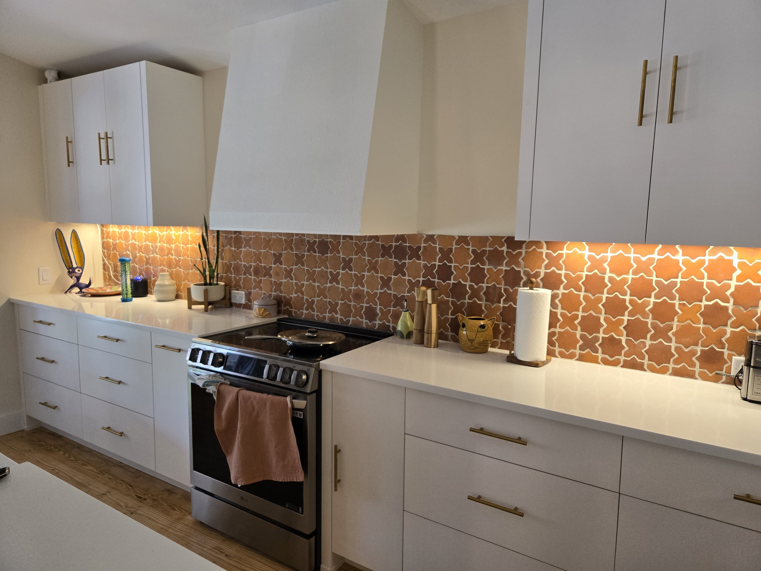 Cle star and cross tile contrast beautifully with crisp white cabinets