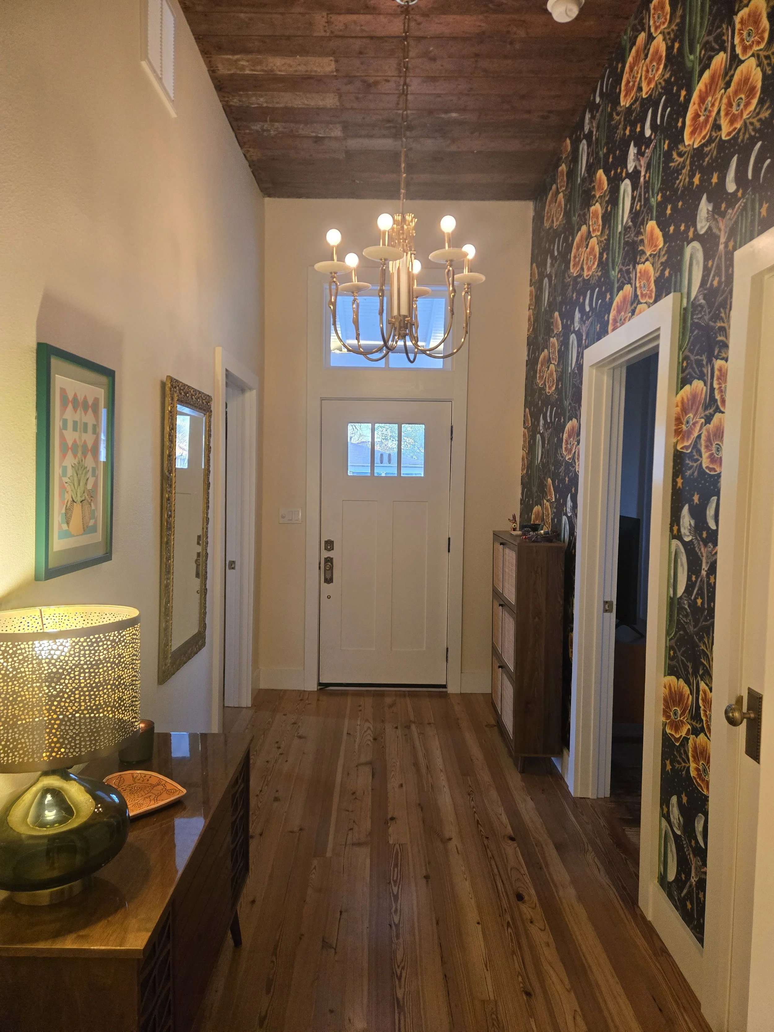 Bold wallpaper and original wood ceilings make a statement in the entry4