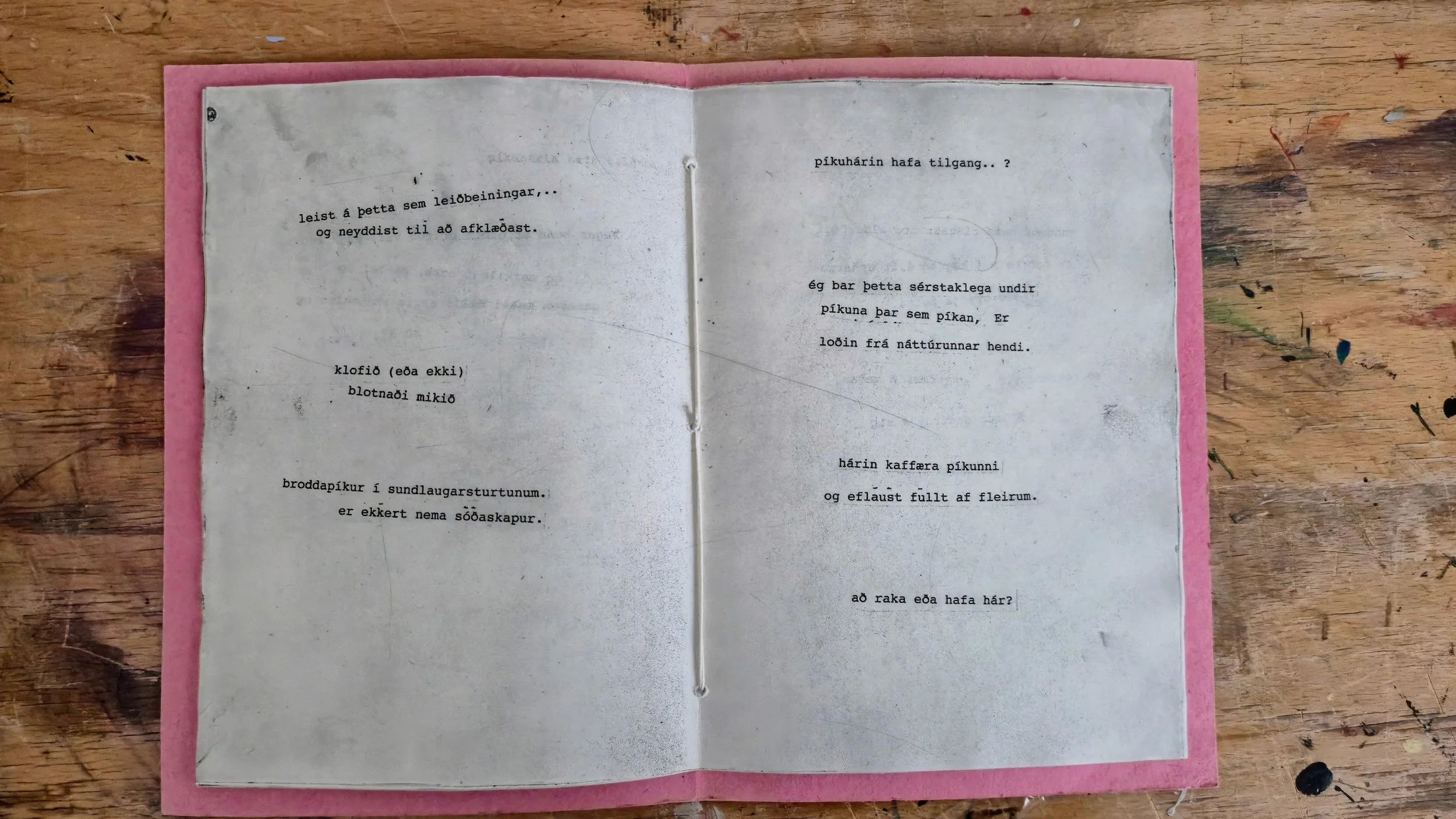 An open book with typewritten pages on a wooden table.