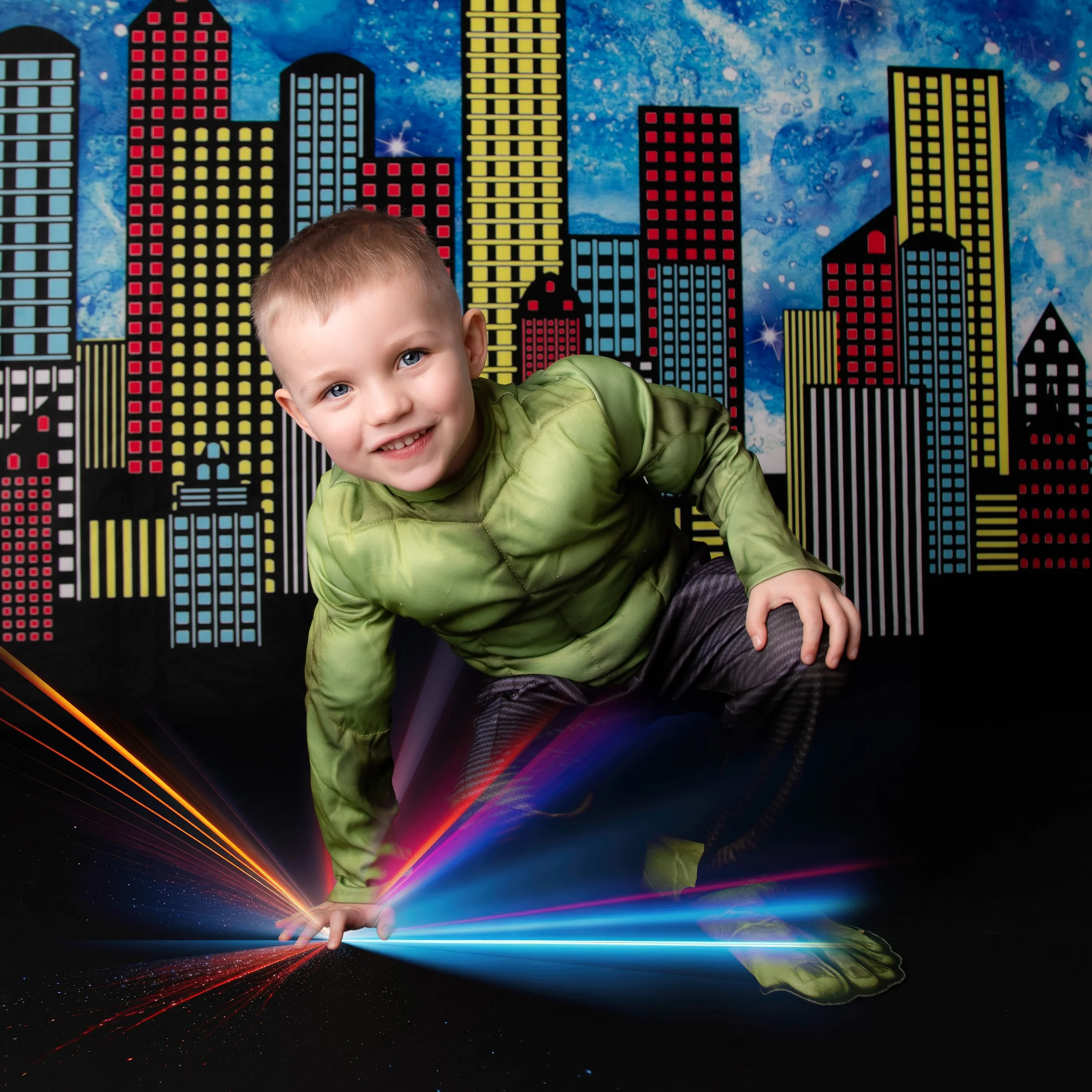 Child dressed as the Hulk, crouching in front of a colorful cityscape backdrop with a cosmic sky, with digital light streaks emerging from one hand.
