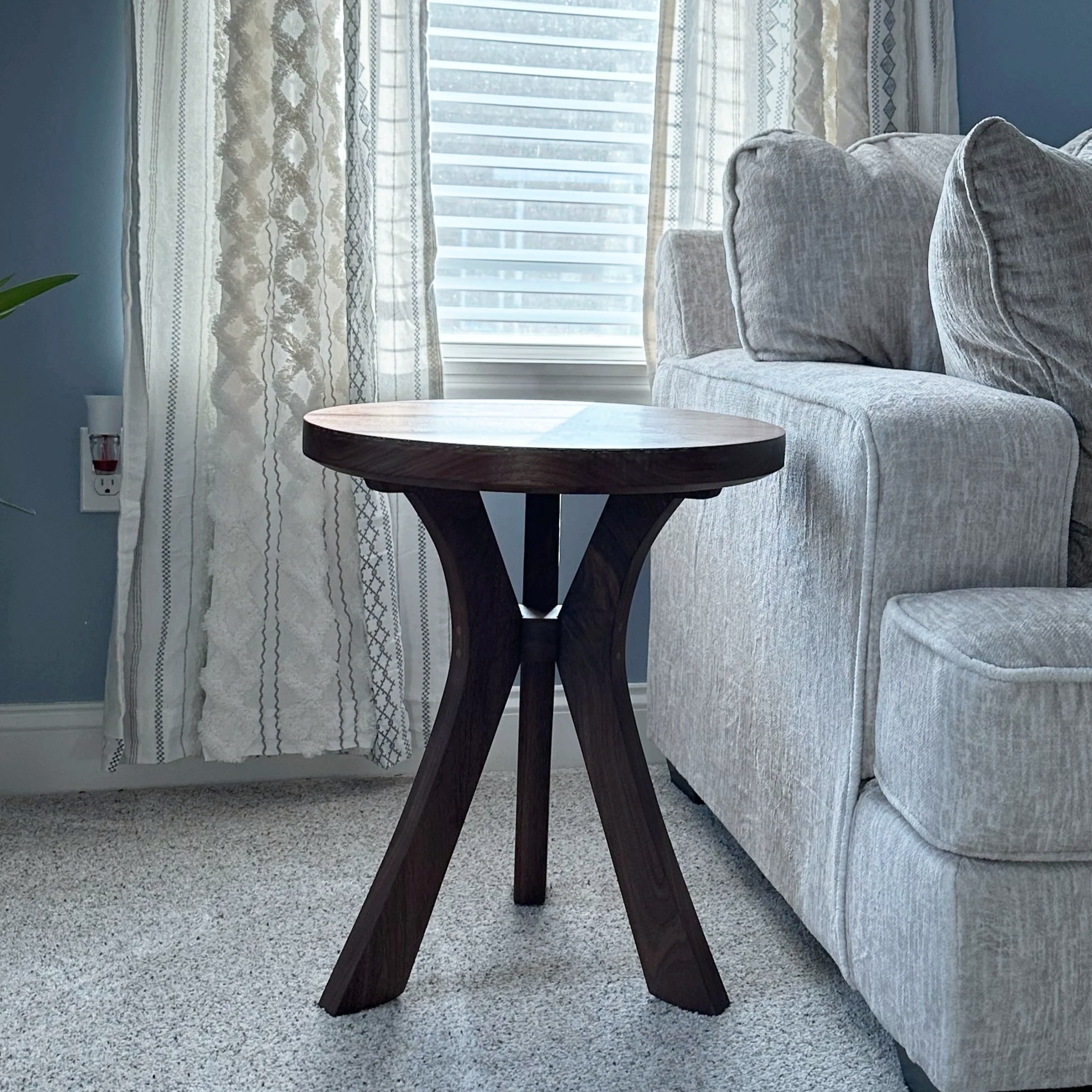 Walnut end table sitting near a window with UV protection