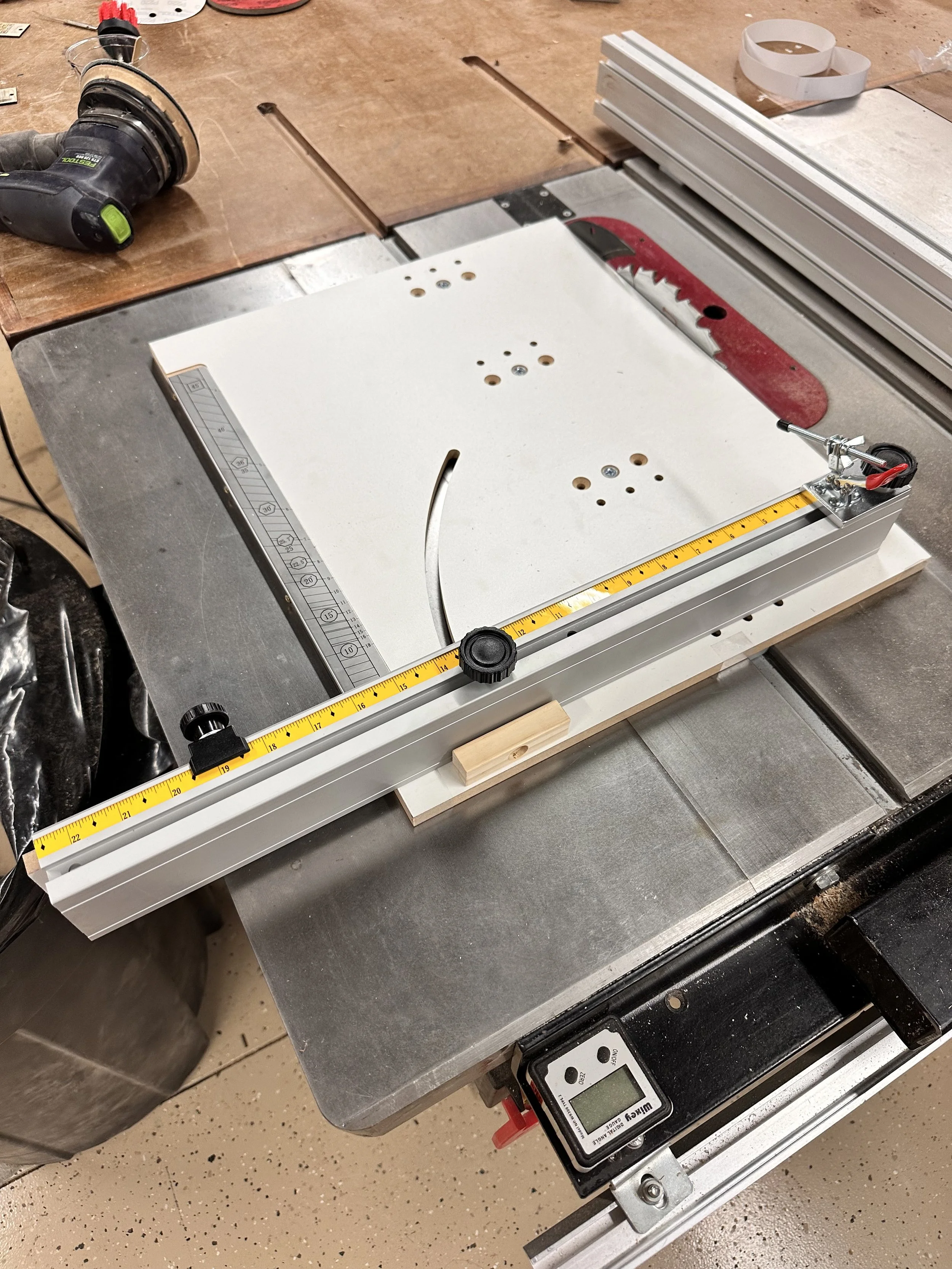 Grizzly 5hp table saw from above with crosscut sled installed for precision repeated cuts