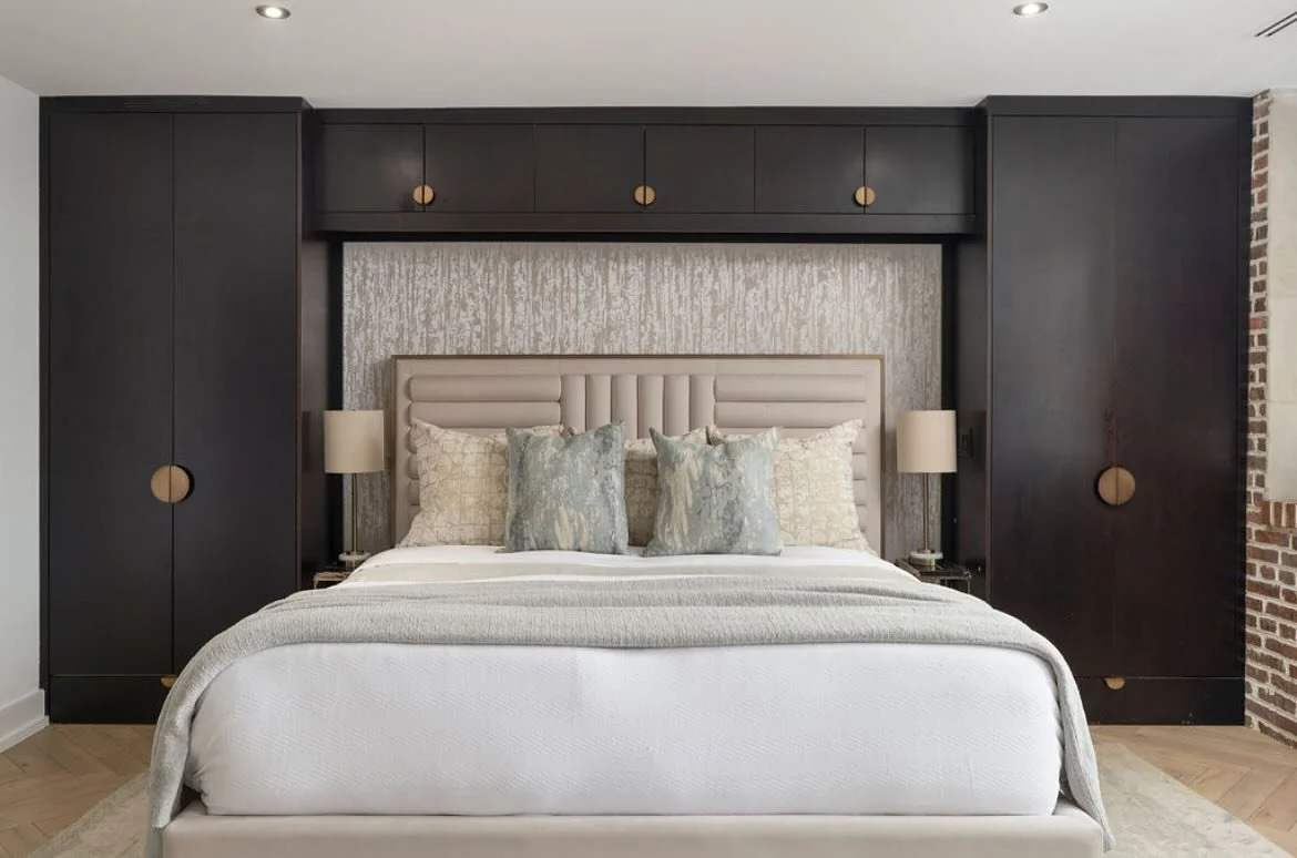 Step into a serene primary bedroom sanctuary where art deco meets modern luxury. This bedroom&rsquo;s centerpiece is an upholstered velvet bed, detailed with soft channeling and a hint of brass that elevates its deco-inspired lines. Surrounding the b