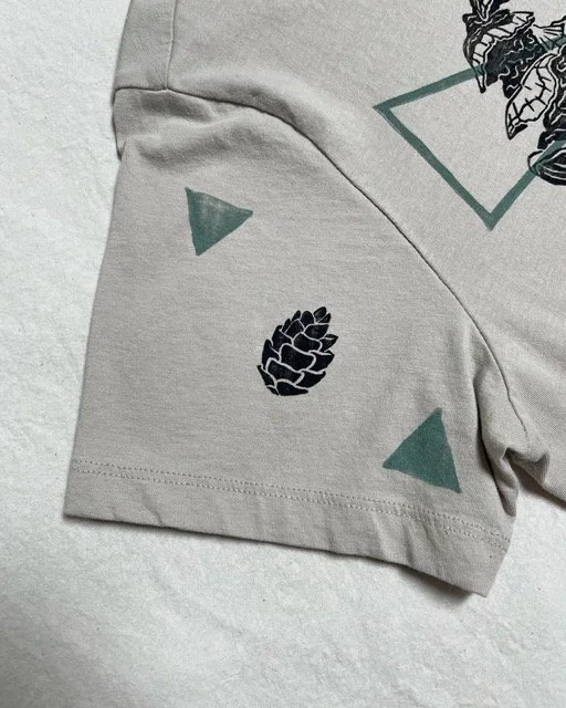 pine cone on shirt sleeve