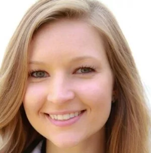 Close-up of a young woman with blonde hair smiling
