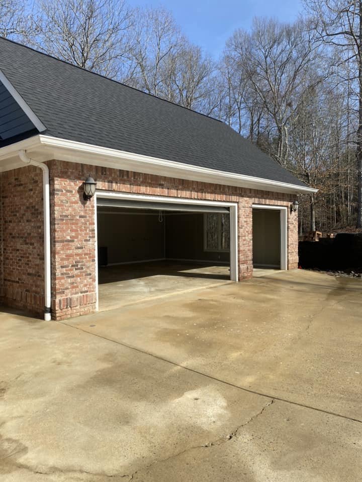 Brick home with a freshly cleaned concrete driveway