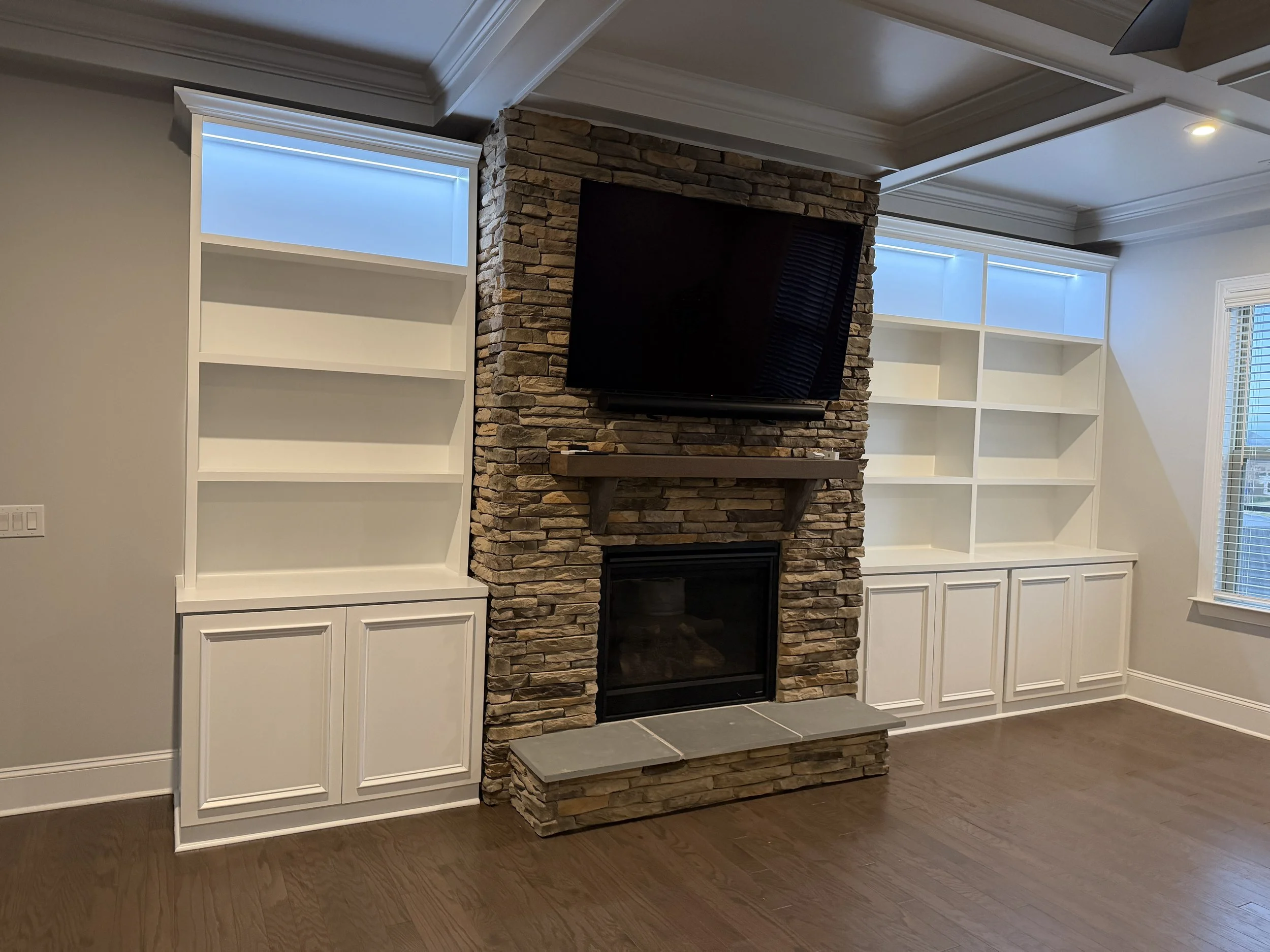 Custom White Built-In Cabinets with LED Lighting – A Modern Fireplace Wall Project