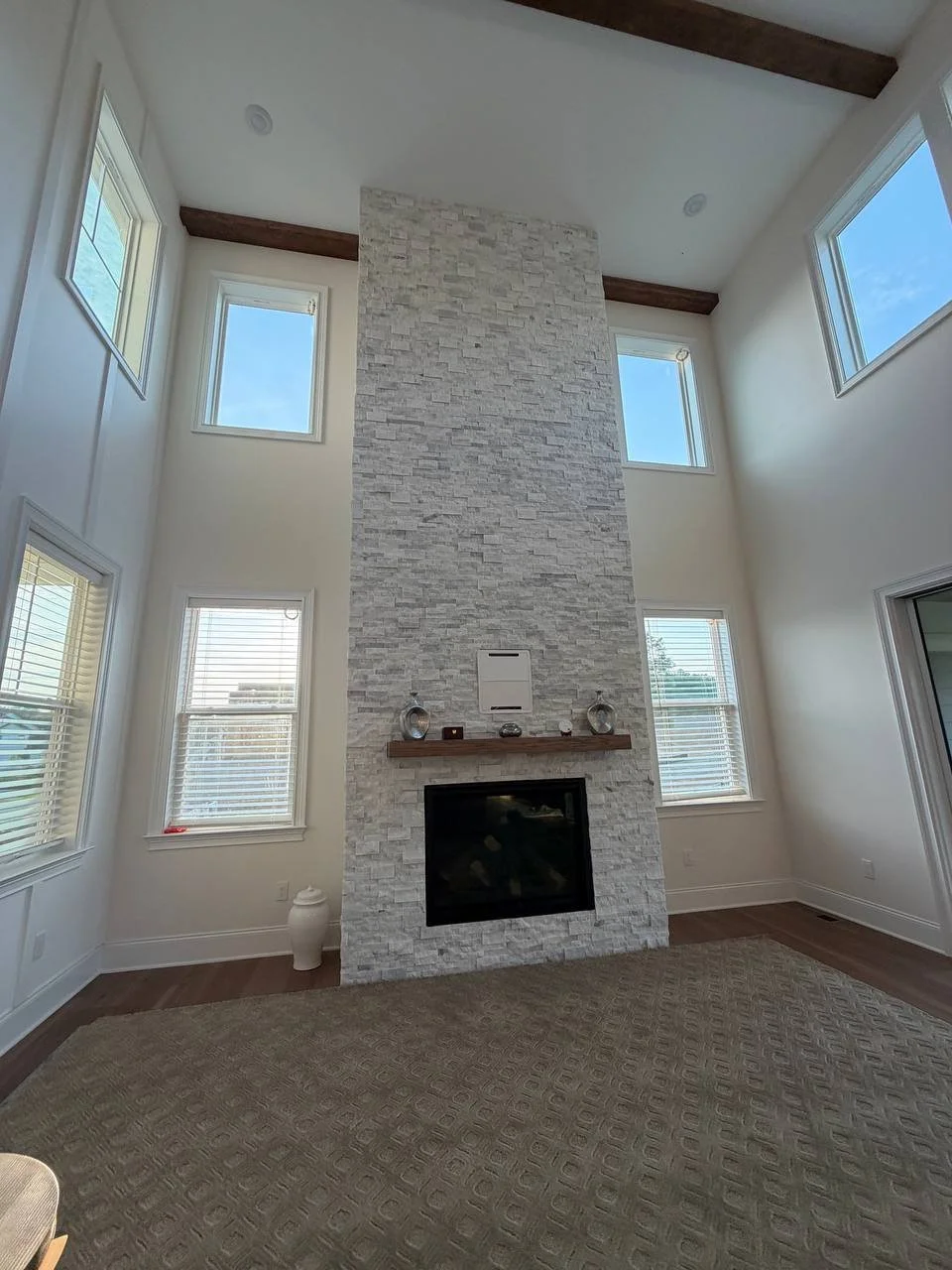 Floor-to-ceiling stacked stone fireplace in a two-story great room, Raleigh NC