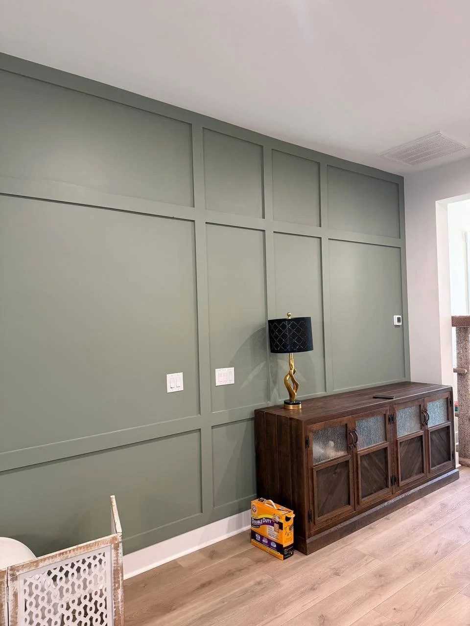 25-foot-wide sage green molding accent wall, Charlotte NC
