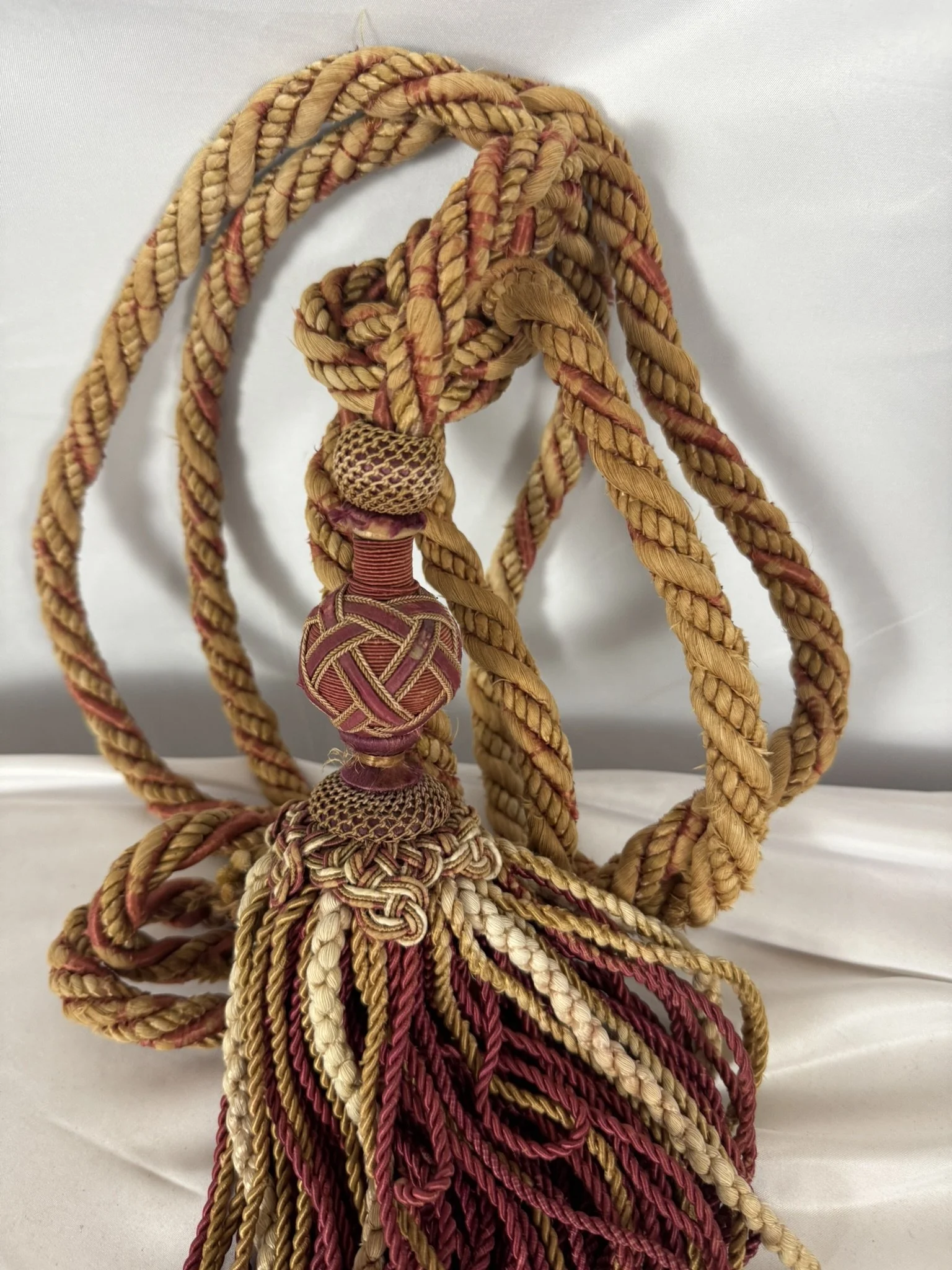 Château passementerie tassel in madder red, gold and cream silk with a deep bullion skirt