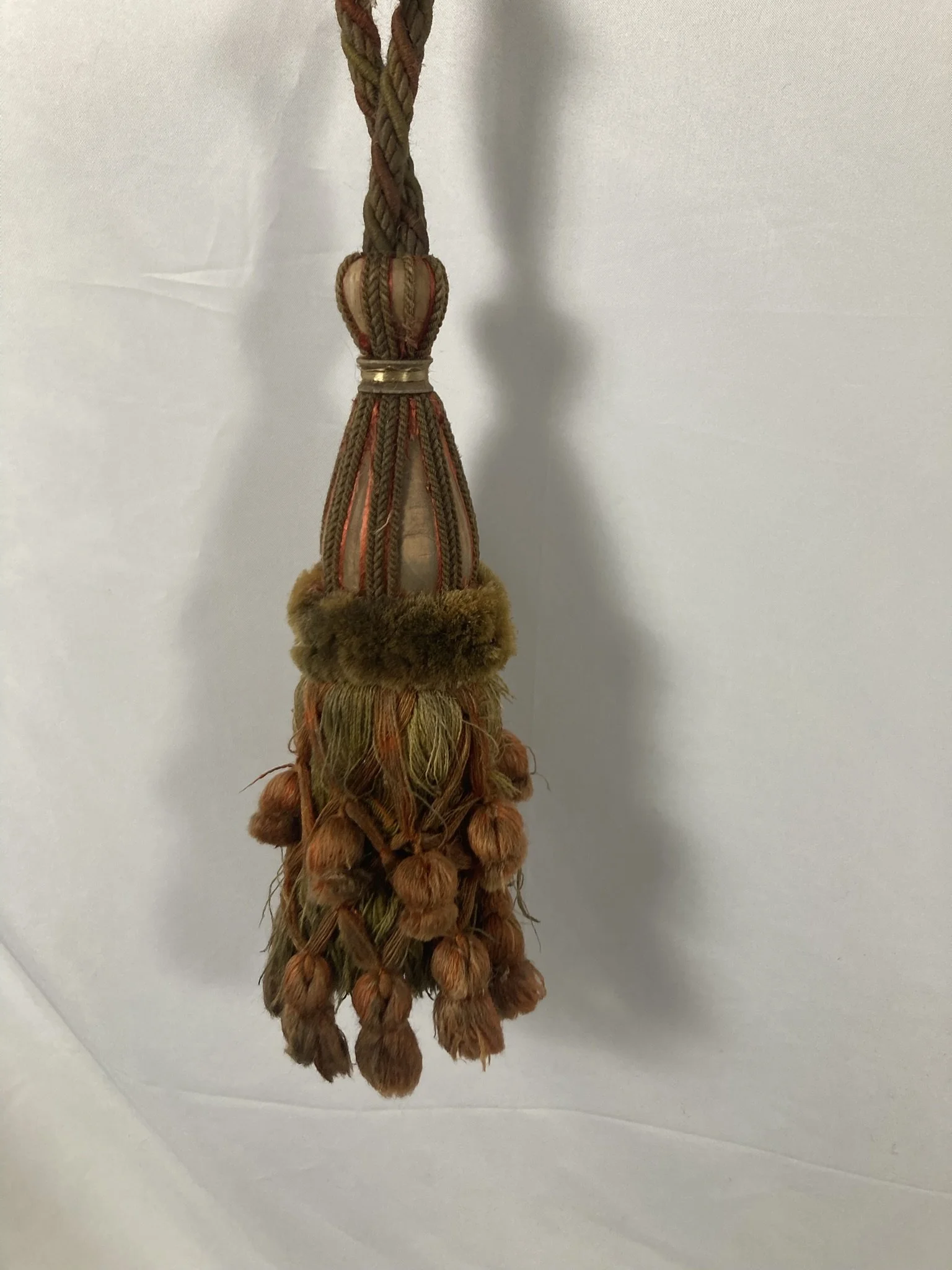 French chateau passementerie tassel tieback in olive and terracotta with velvet ruff and drop tassel skirt