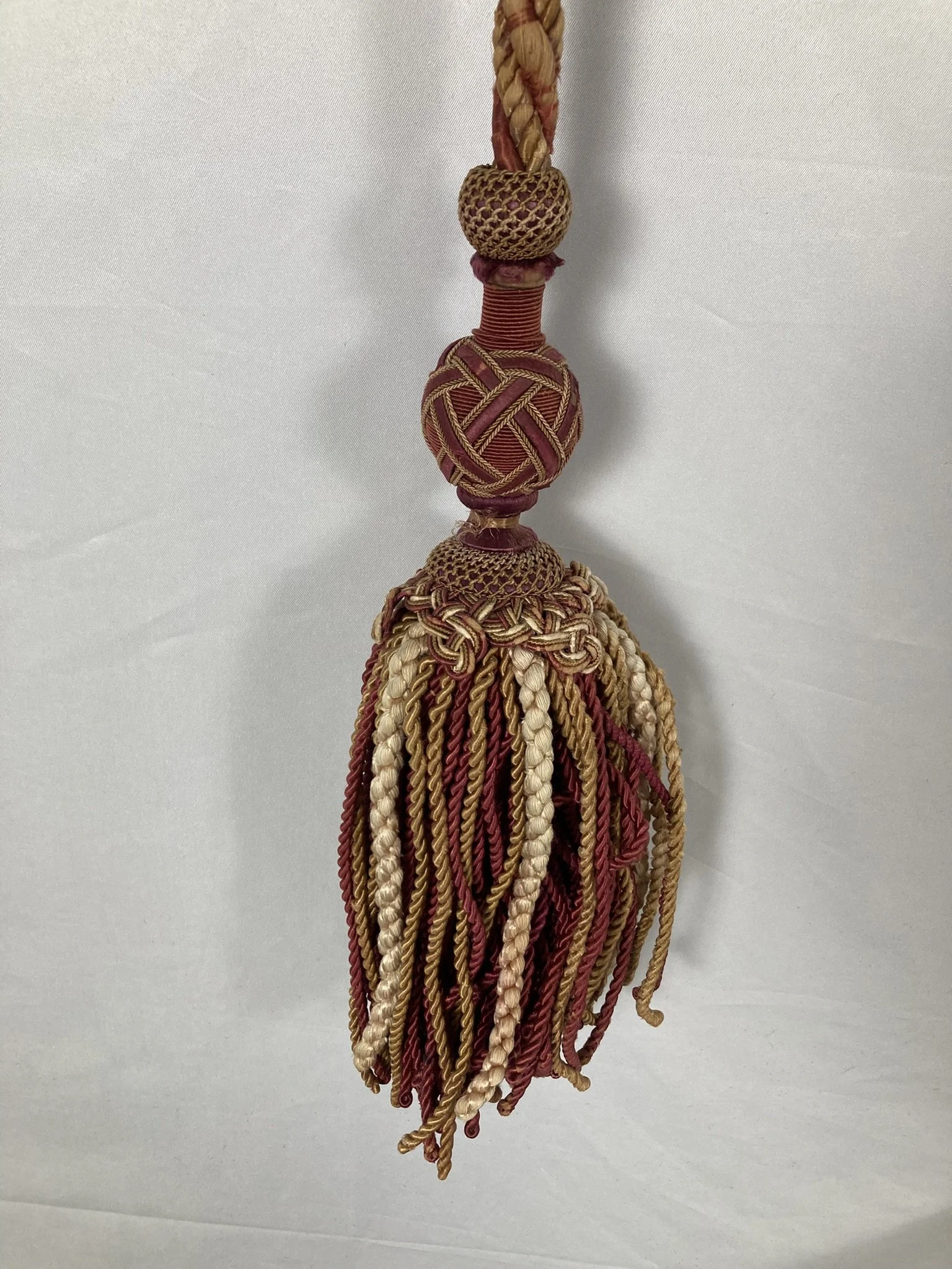 Château passementerie tassel in madder red, gold and cream silk with a deep bullion skirt