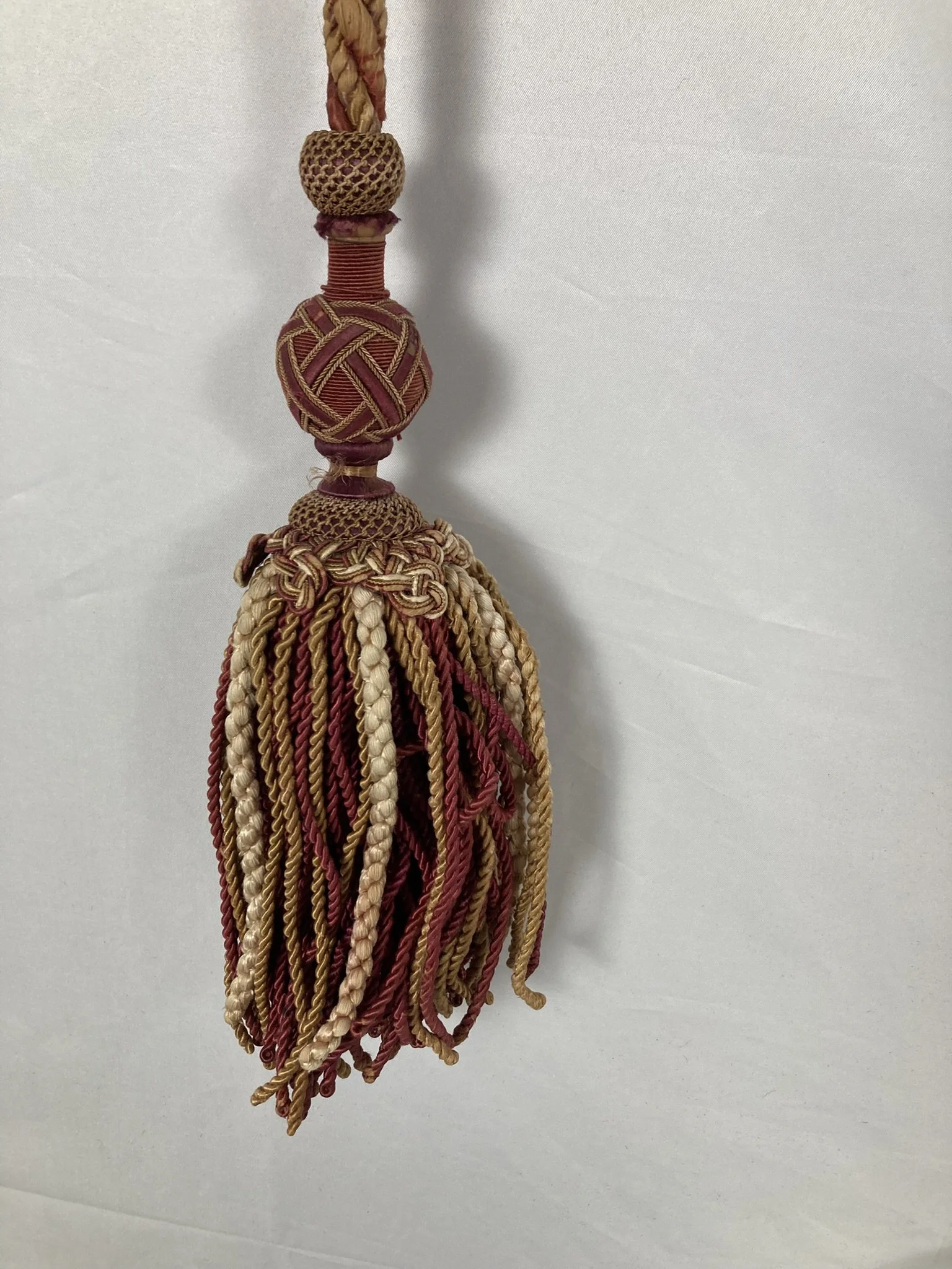 Château passementerie tassel in madder red, gold and cream silk with a deep bullion skirt