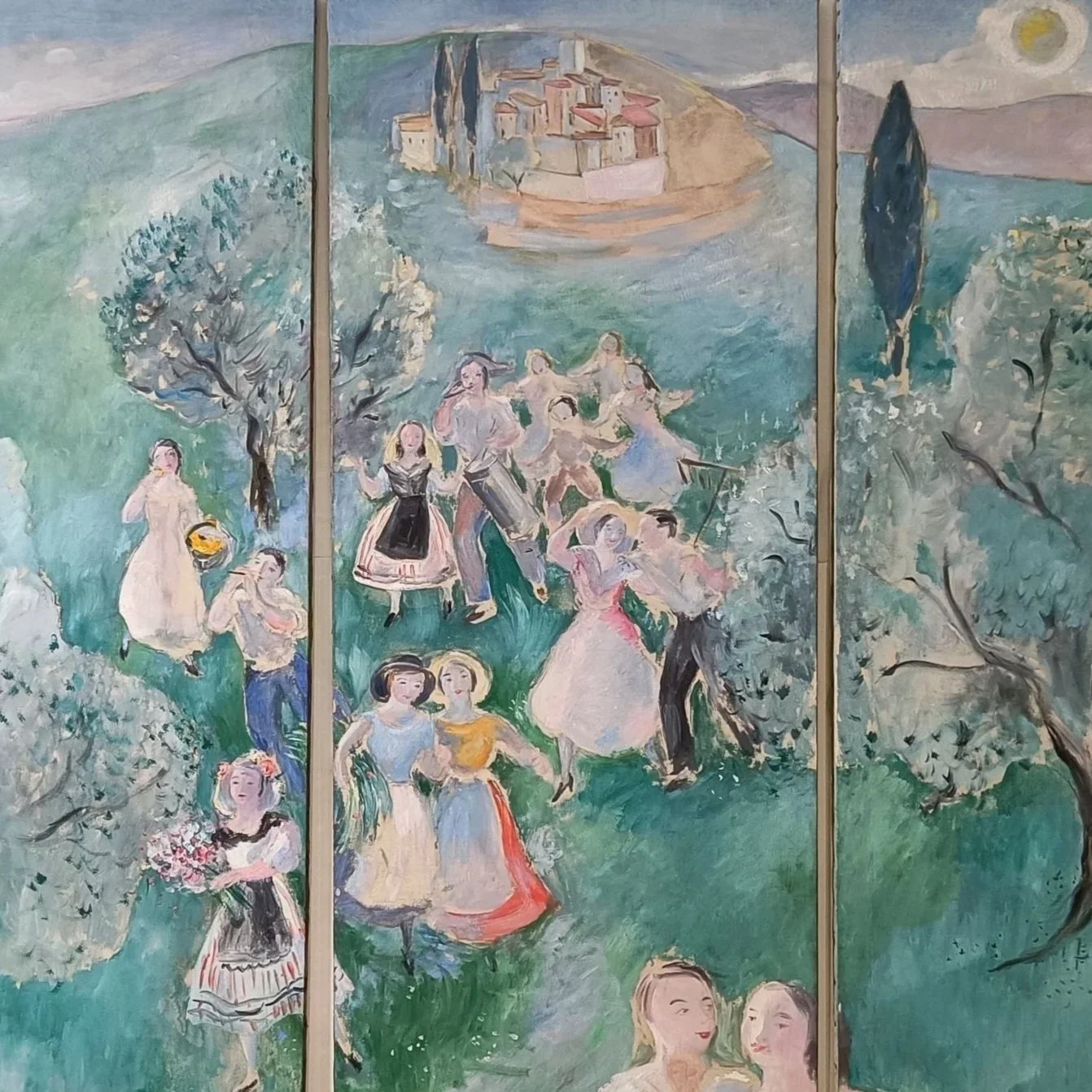 European painted decorative panel featuring idyllic pastoral landscape with classical architecture, cypress trees, and elegantly dressed figures in a riverside setting