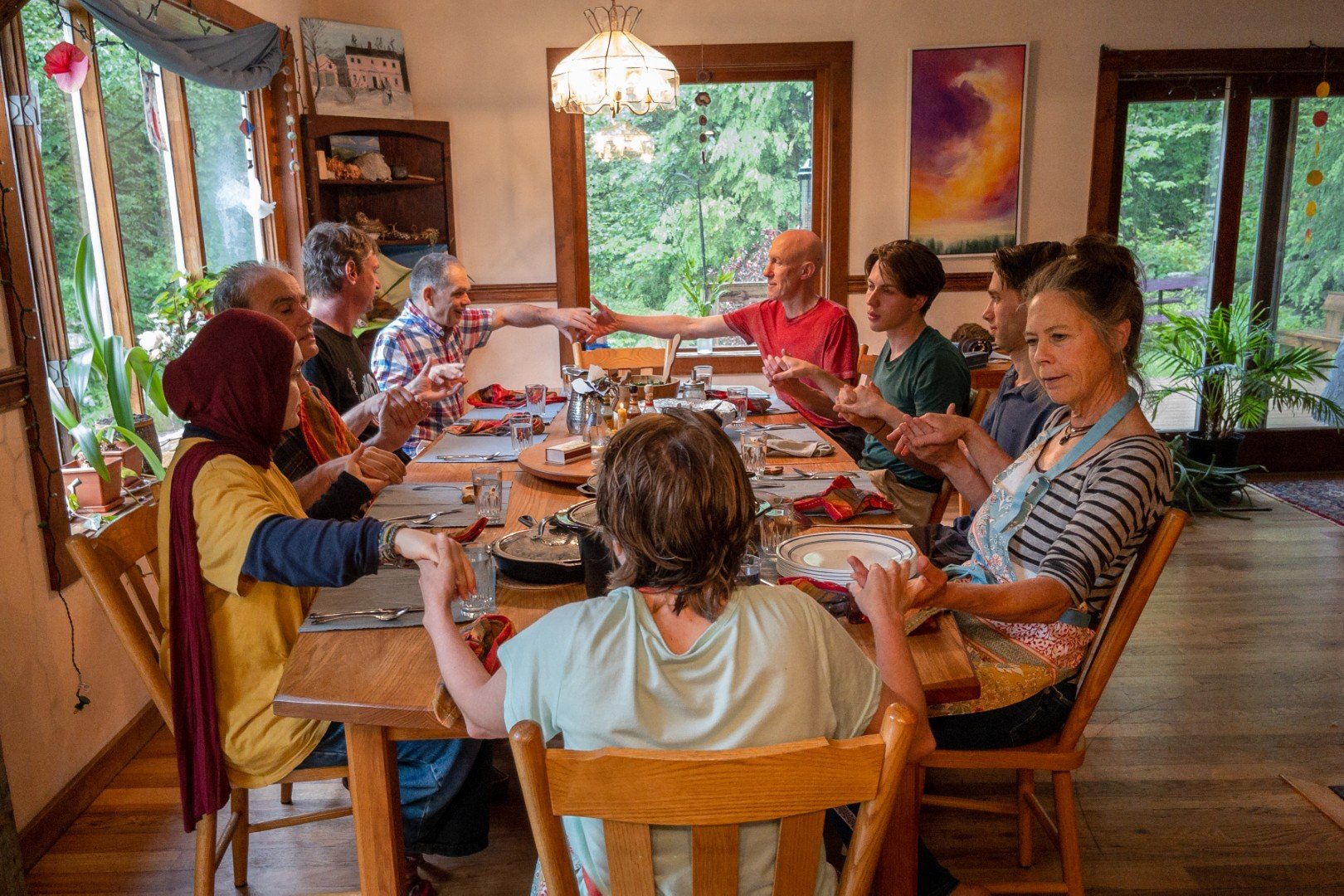 People saying grace around the dinner table.