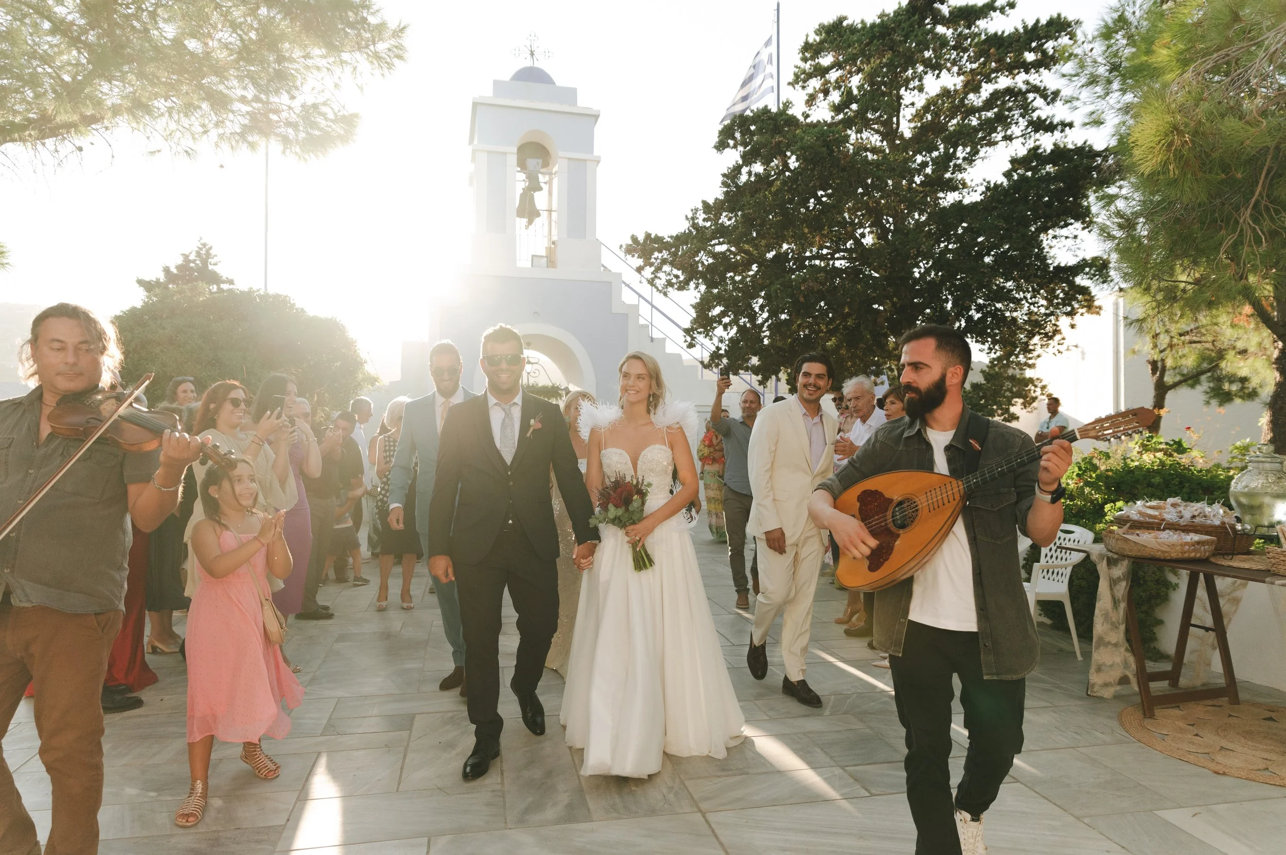 Destination wedding in Greece – couple entering the church yard before the ceremony