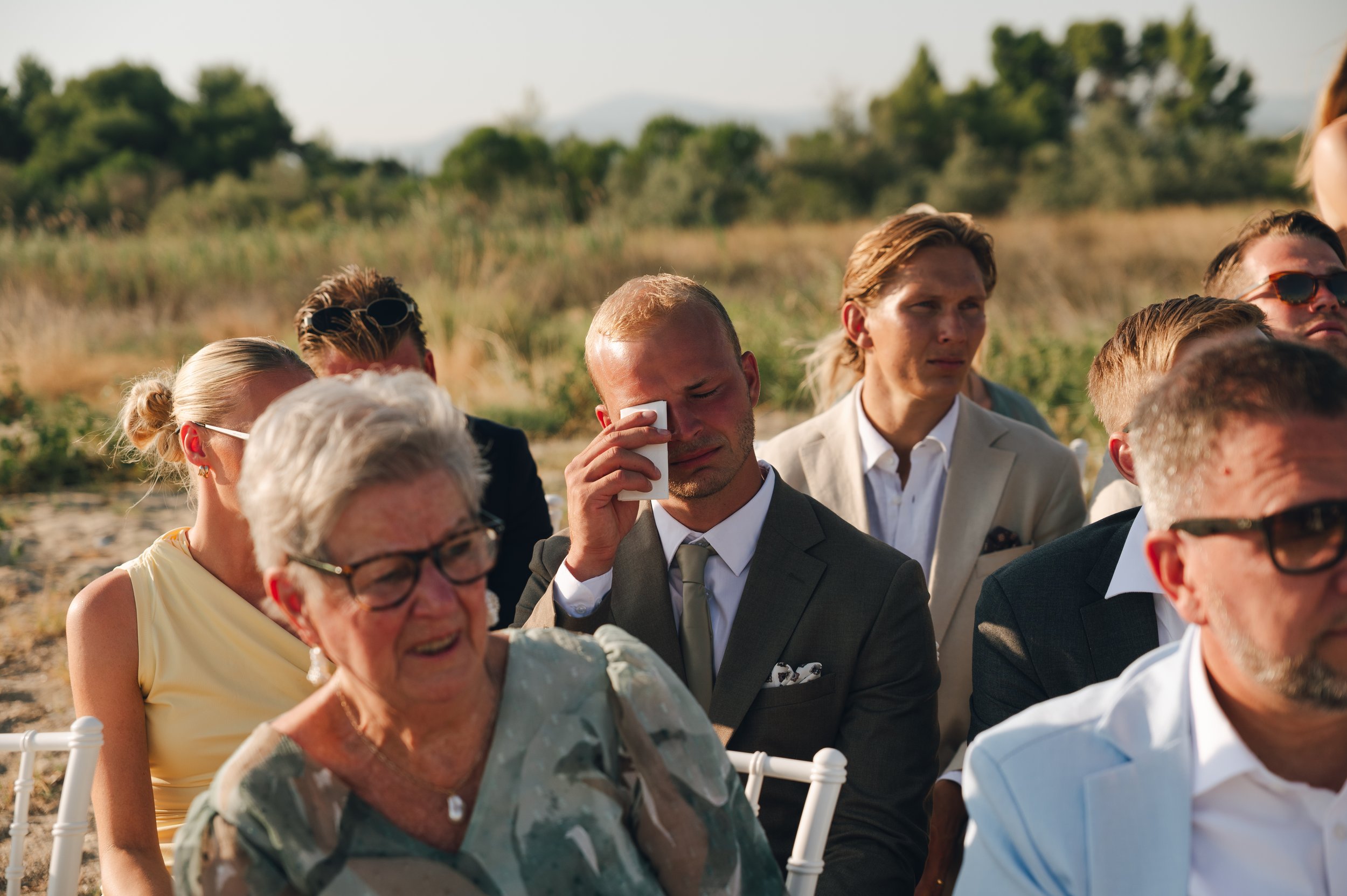 Emotional wedding moment captured naturally during a ceremony in Greece