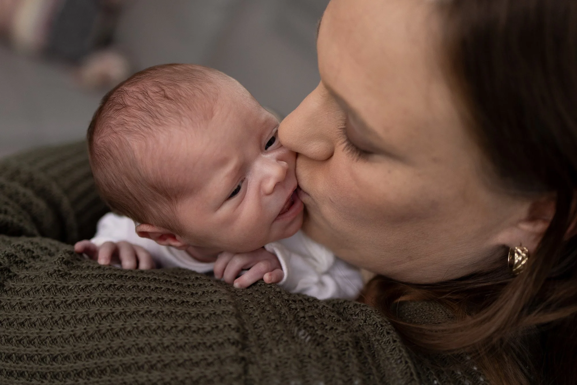 mom kissing newborn daughter showing love.jpg