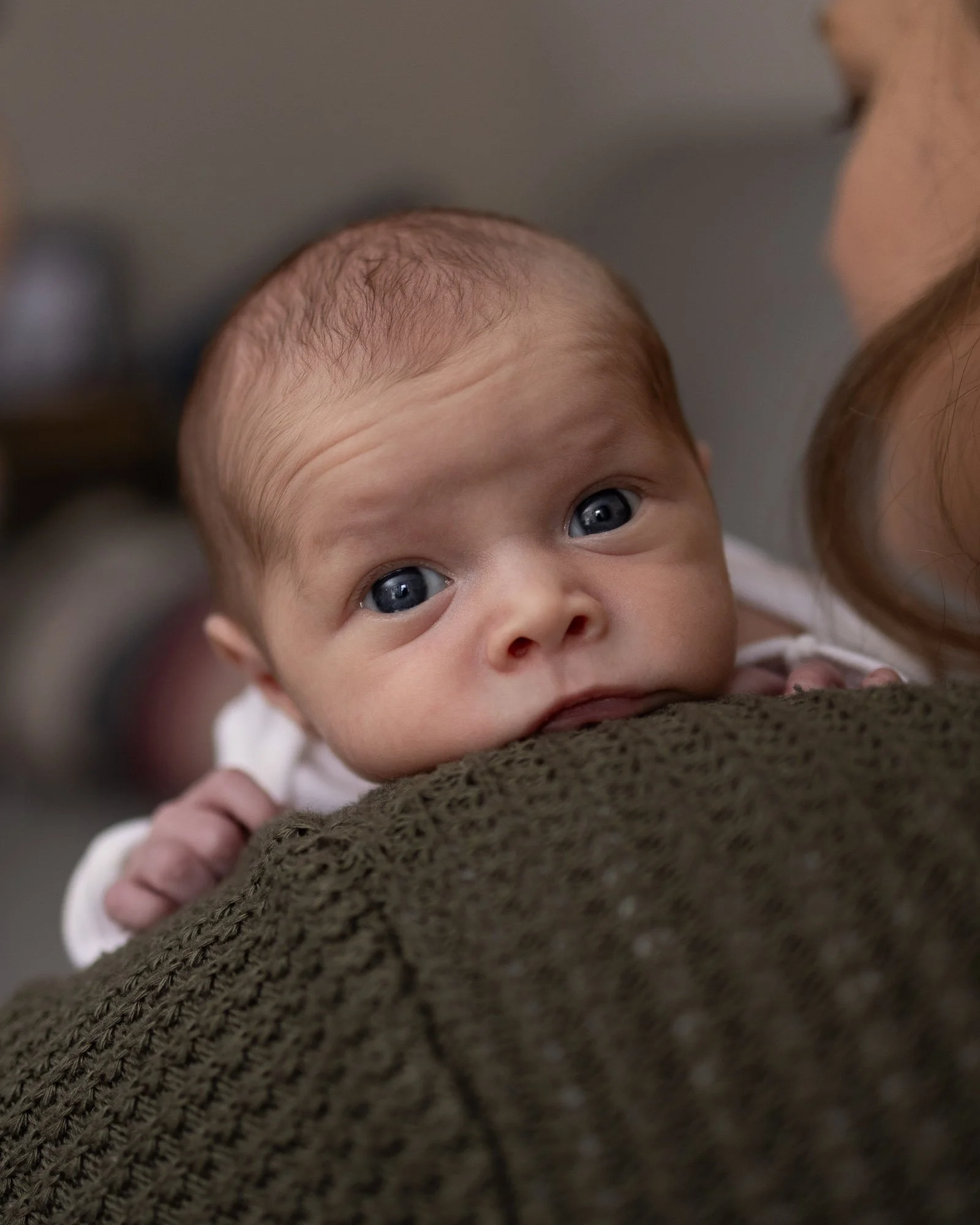 newborn girl on mom with wide open eyes.jpg