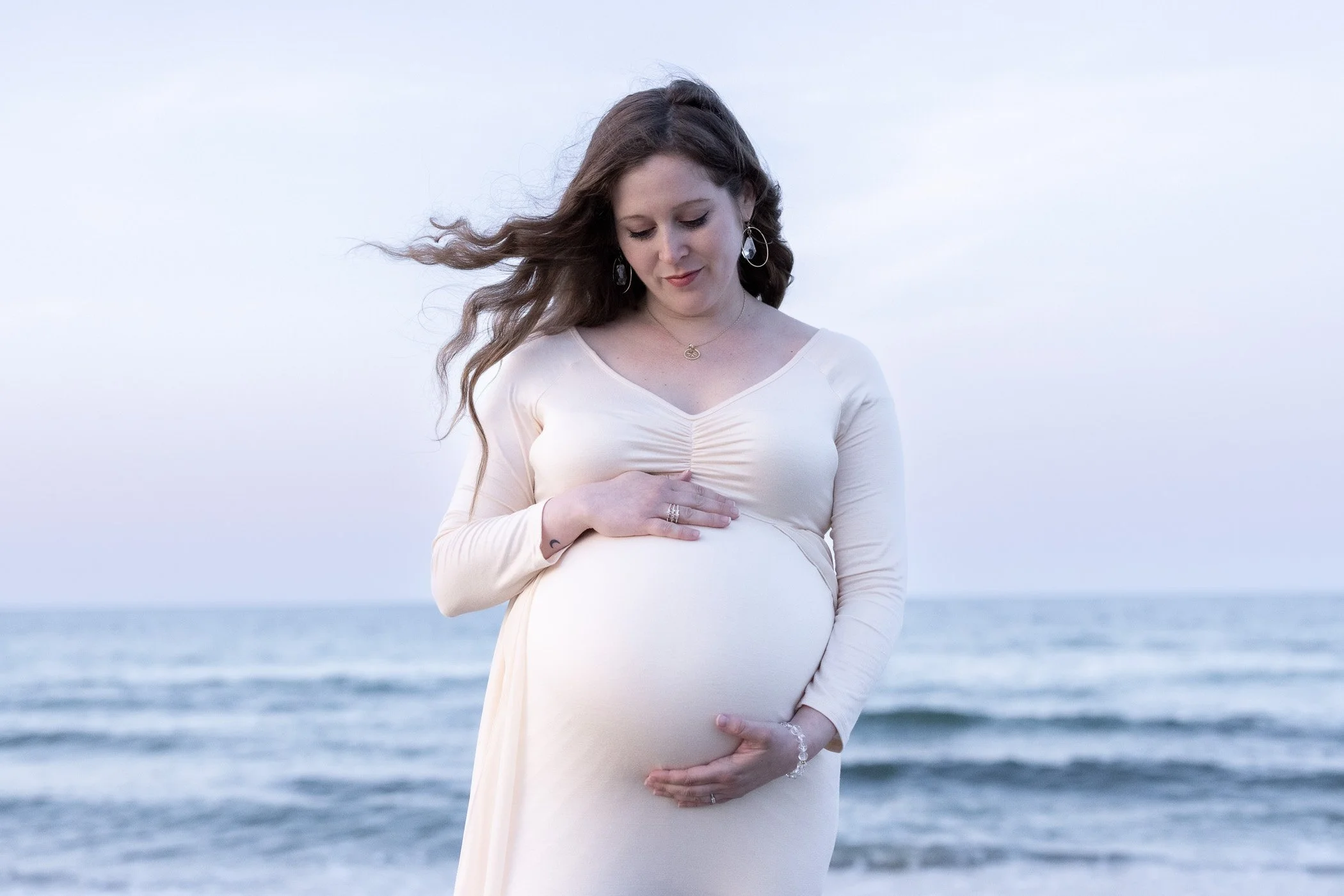 Maternity picture of mom holding belly on the South Shore