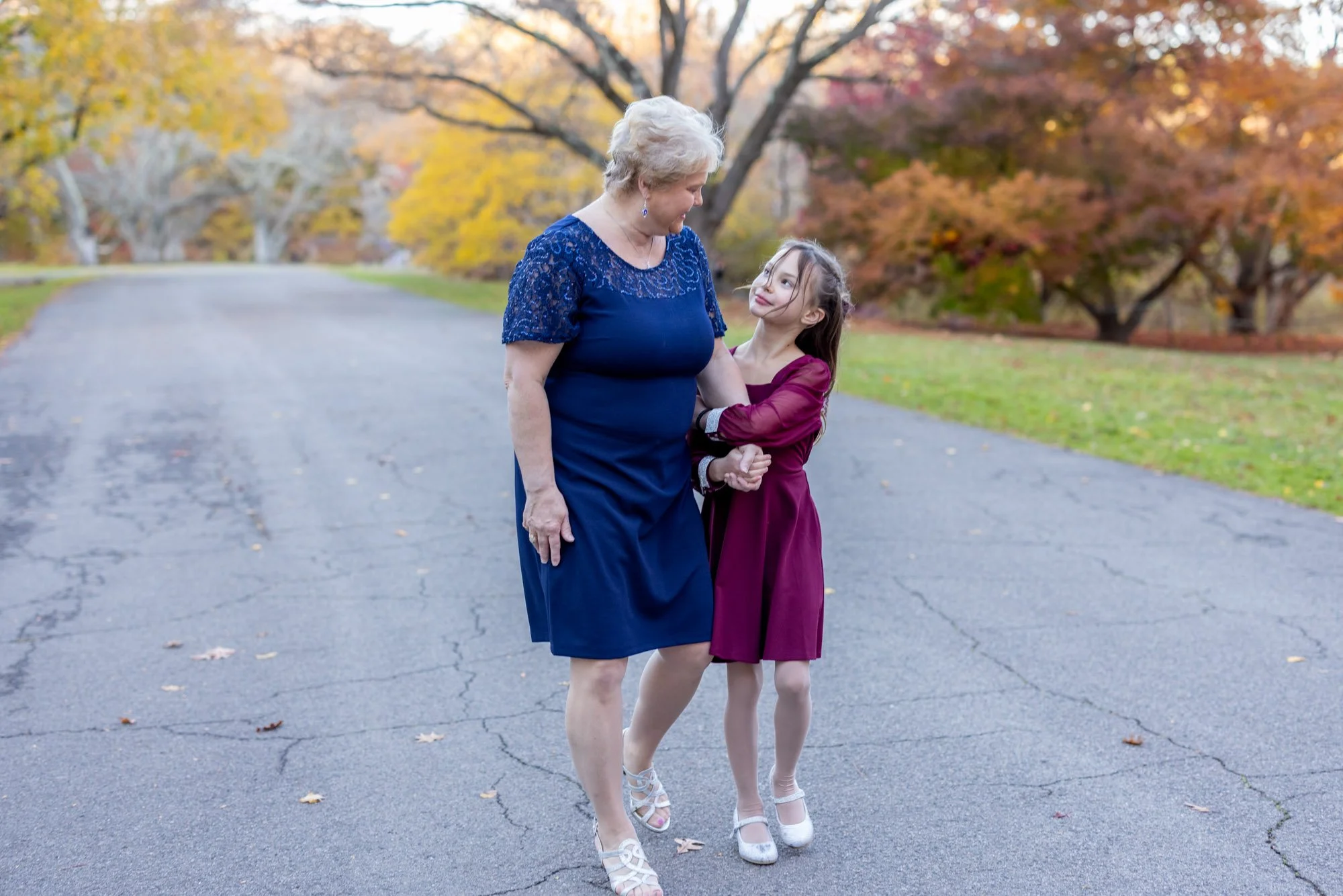 grandmother and granddaughter looking lovingly at each other in autumn