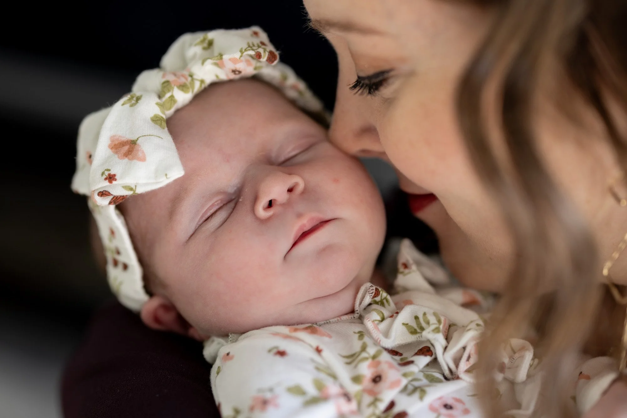 mom face to face with newborn daugher showing love.jpg
